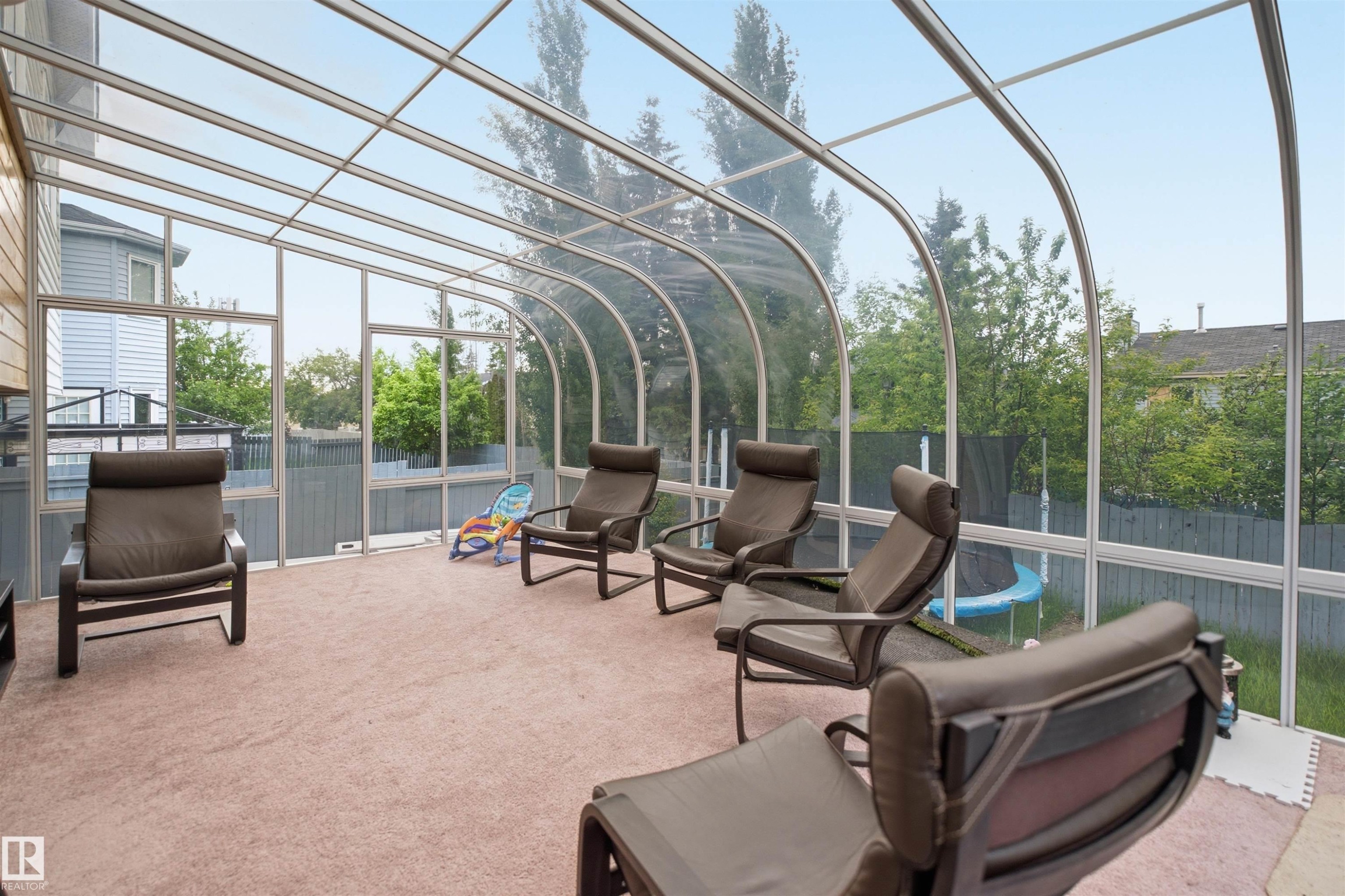Curved glass sunroom with aluminum framing, full height windows, and light beige carpeting - 3220 42A Avenue, Edmonton, AB