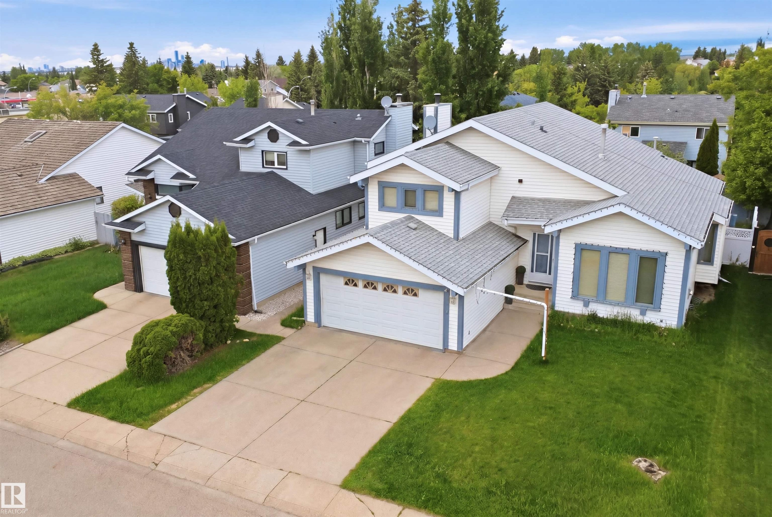 Multi-level residence featuring a prominent pitched roofline and light-colored siding - 3220 42A Avenue, Edmonton, AB
