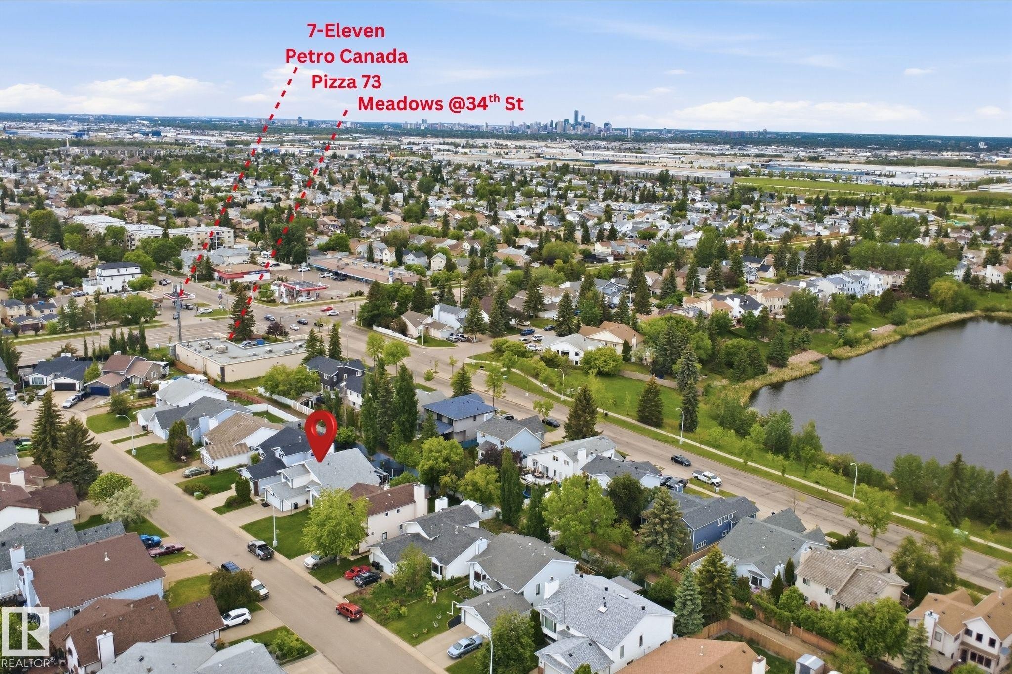 Residential neighborhood featuring single-family homes, mature trees, and a nearby body of water - 3220 42A Avenue, Edmonton, AB