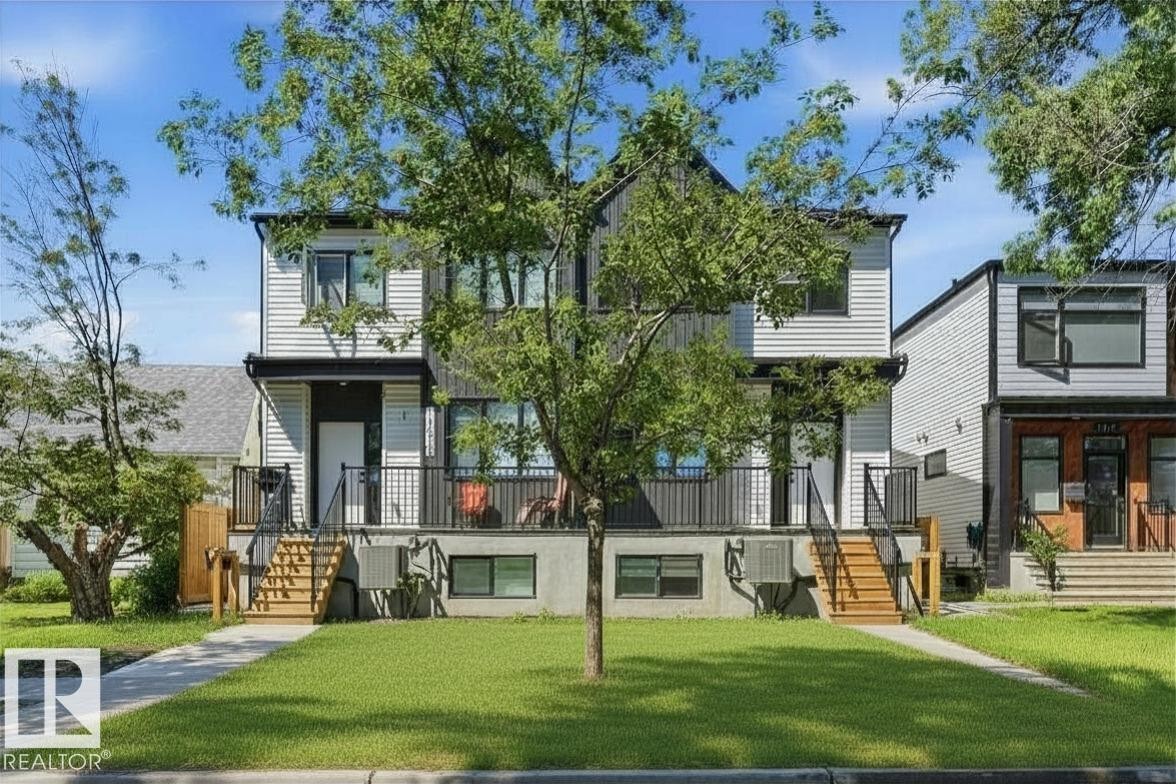 Contemporary duplex with light-colored siding and dark trim accents - 11012 132 Street, Edmonton, AB