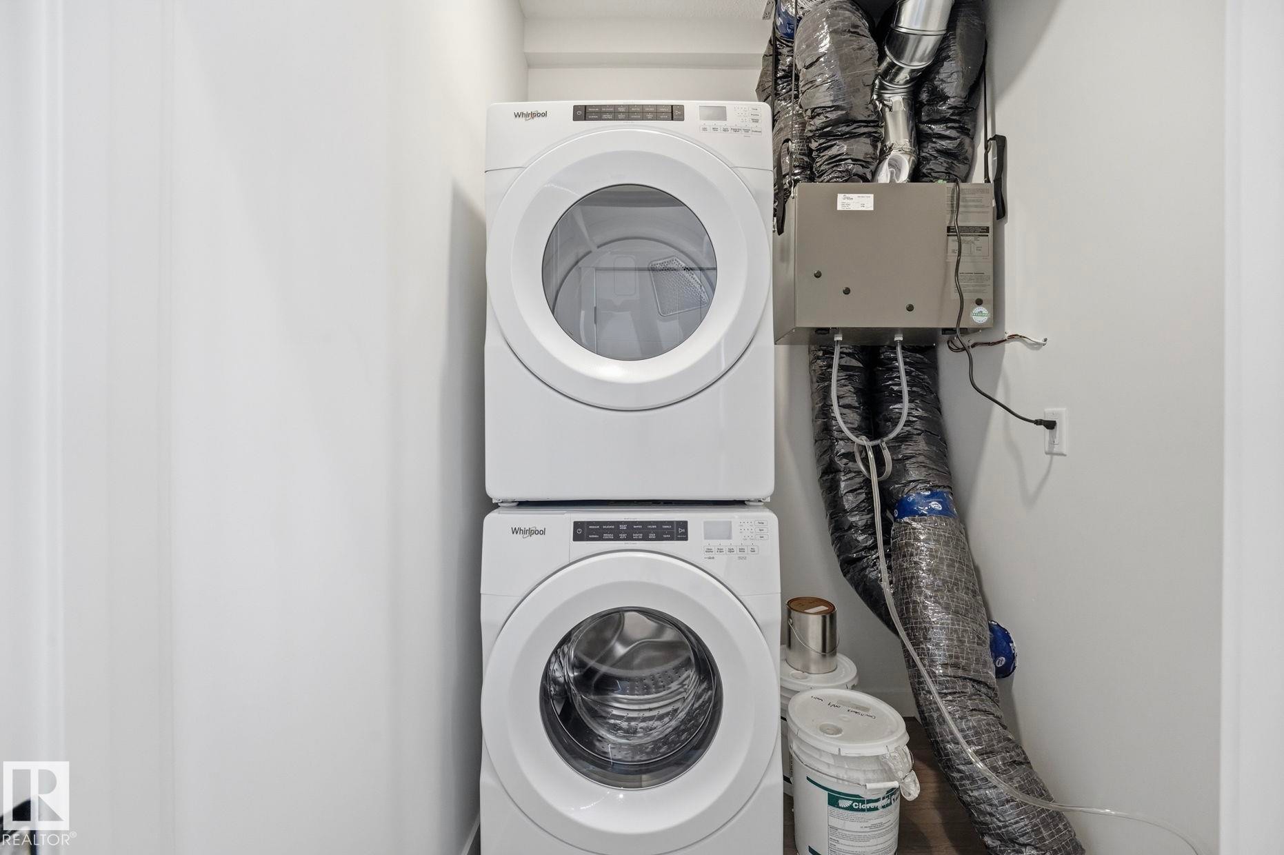 Dedicated laundry area featuring a stacked washer and dryer - 11012 132 Street, Edmonton, AB