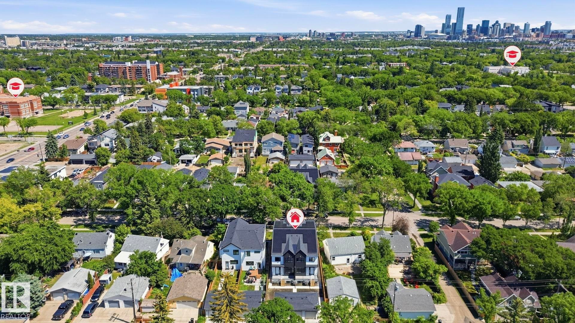 Aerial perspective showcasing a residential neighborhood with a downtown skyline visible in the distance - 11012 132 Street, Edmonton, AB