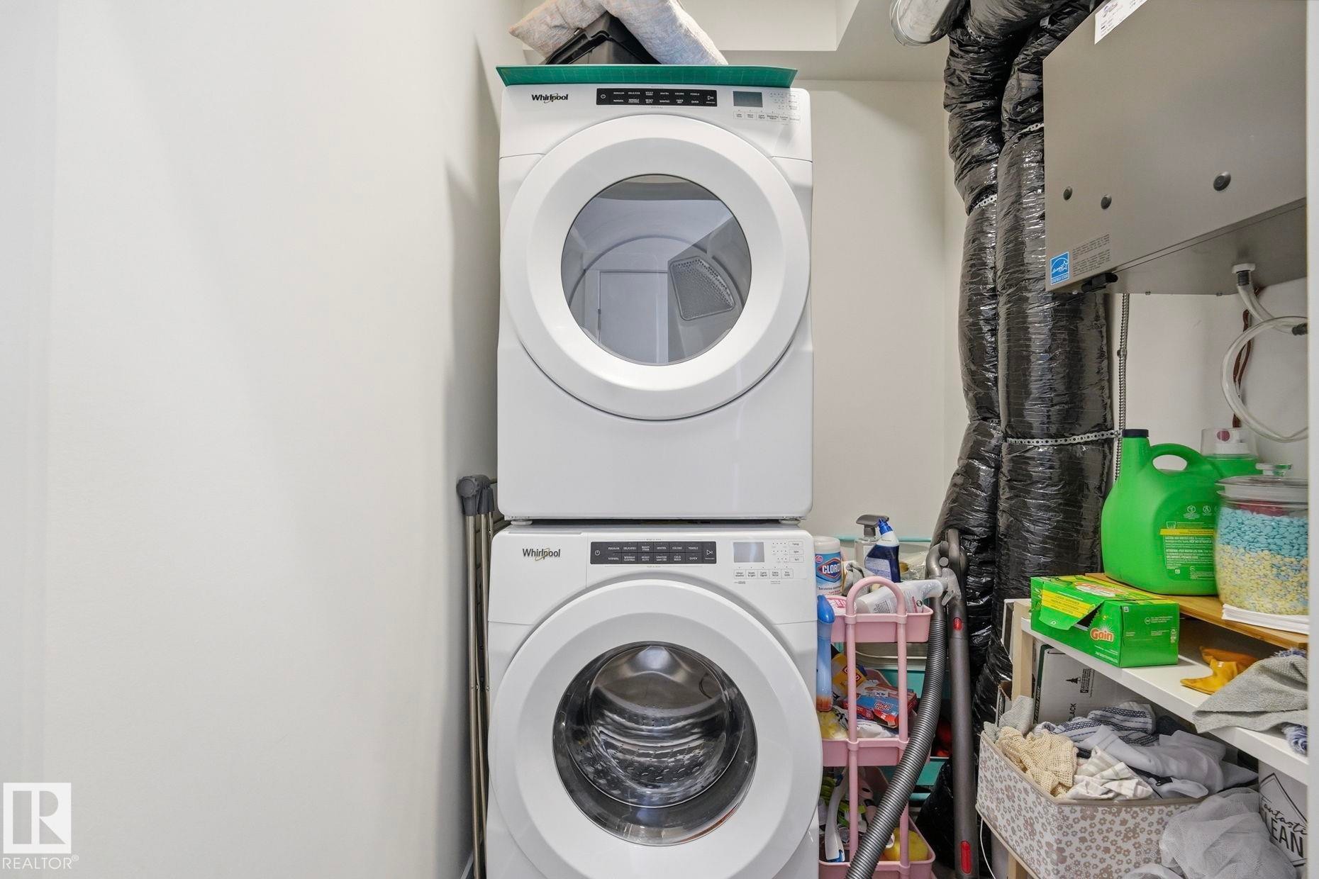 Dedicated laundry area featuring a stacked washer and dryer - 11007 132 Street, Edmonton, AB