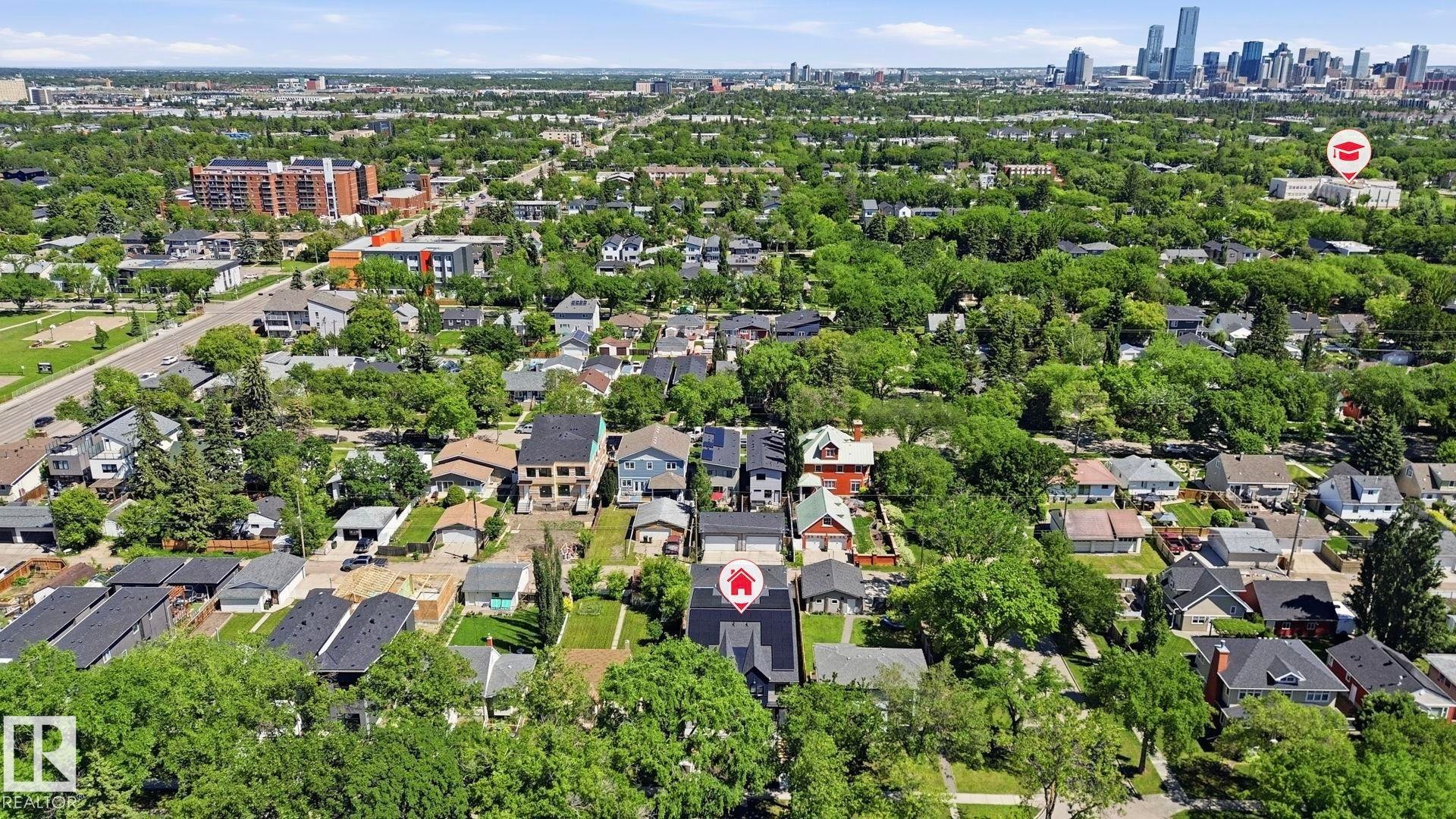 Residential neighborhood featuring mature tree canopies and a distant city skyline - 11007 132 Street, Edmonton, AB