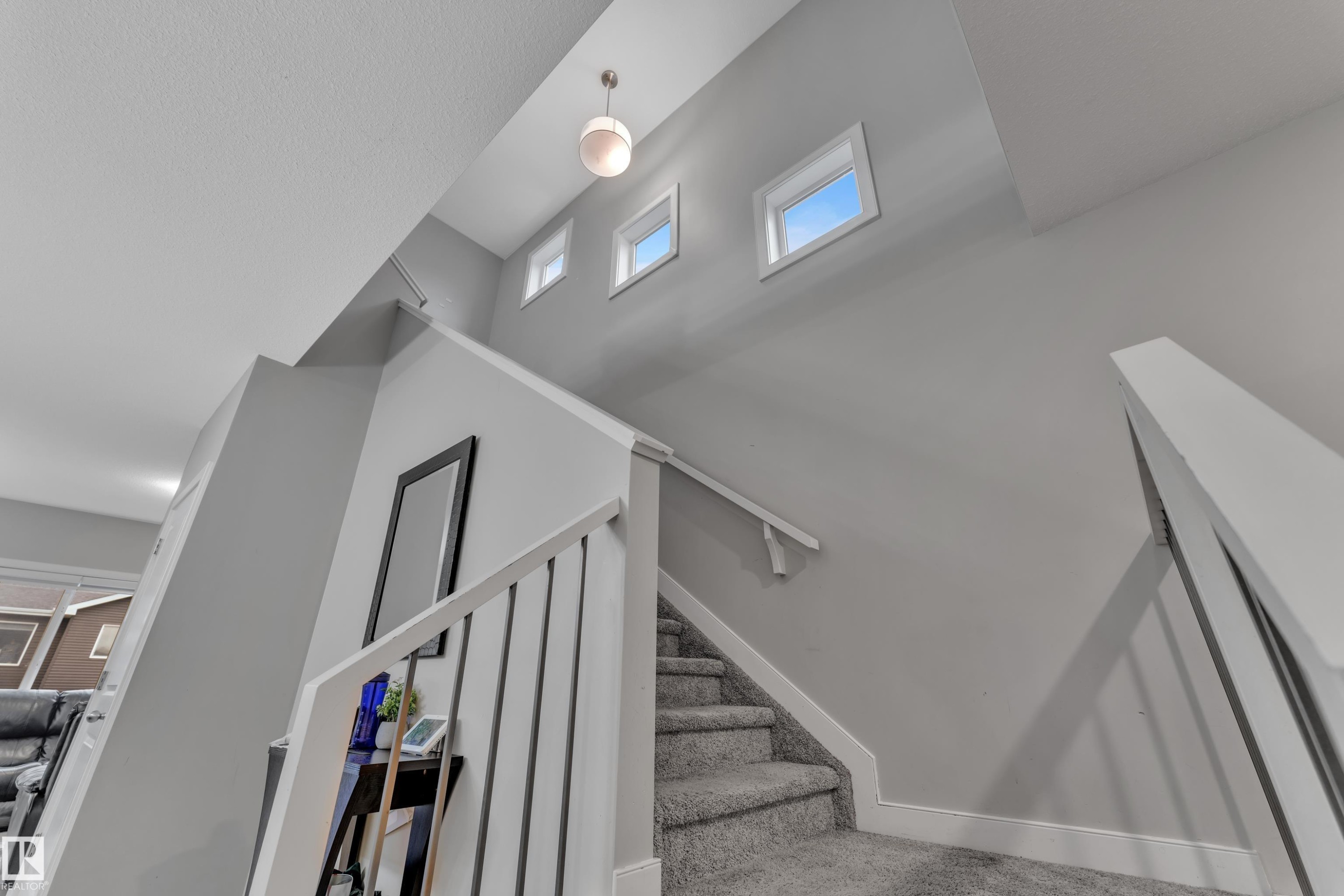 Carpeted staircase with white balusters and handrails - 9328 Pear Link Link, Edmonton, AB