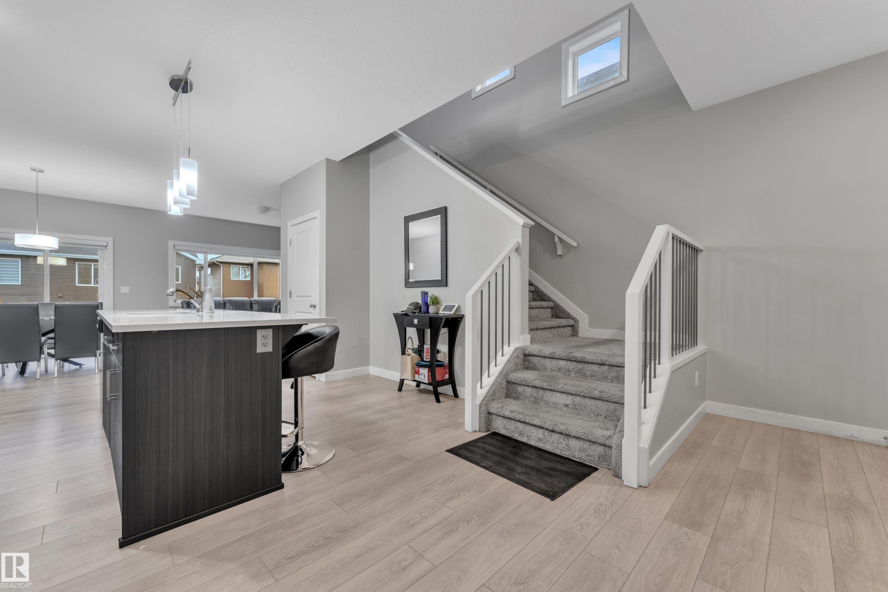 Open-concept living space with light wood-finish flooring - 9328 Pear Link Link, Edmonton, AB