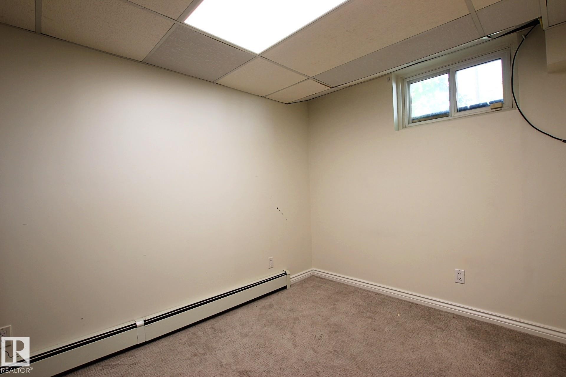 Carpeted room with a drop ceiling and recessed lighting - 11242 56 Street, Edmonton, AB