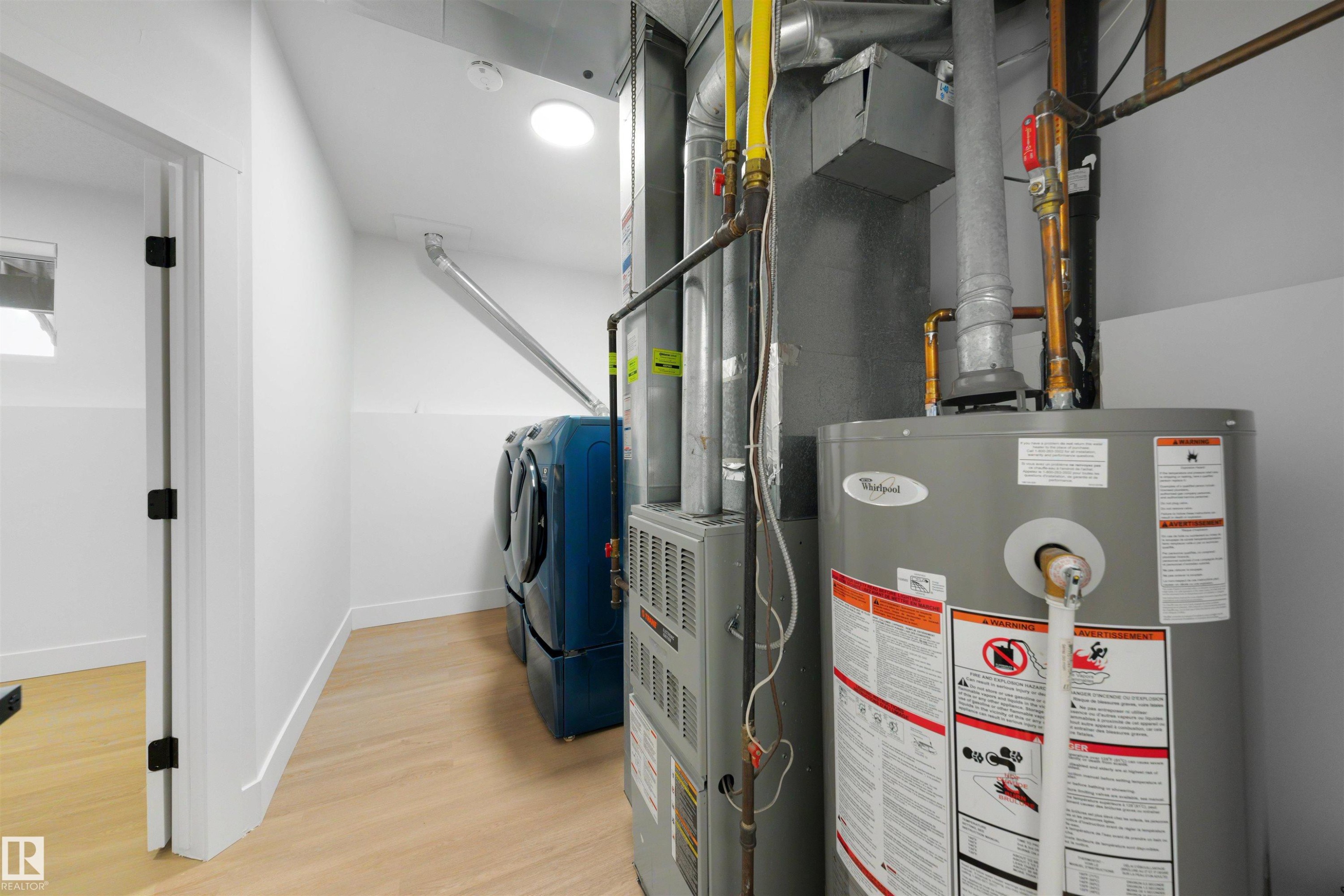 Dedicated mechanical room featuring a water heater and furnace - 12611 47 Street, Edmonton, AB