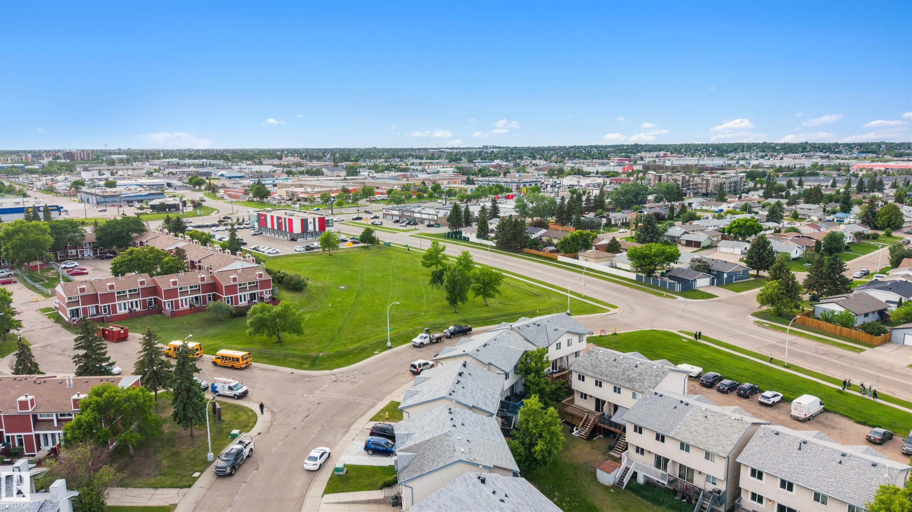 Aerial perspective showcasing red and light-colored multi-unit residential buildings - 12611 47 Street, Edmonton, AB
