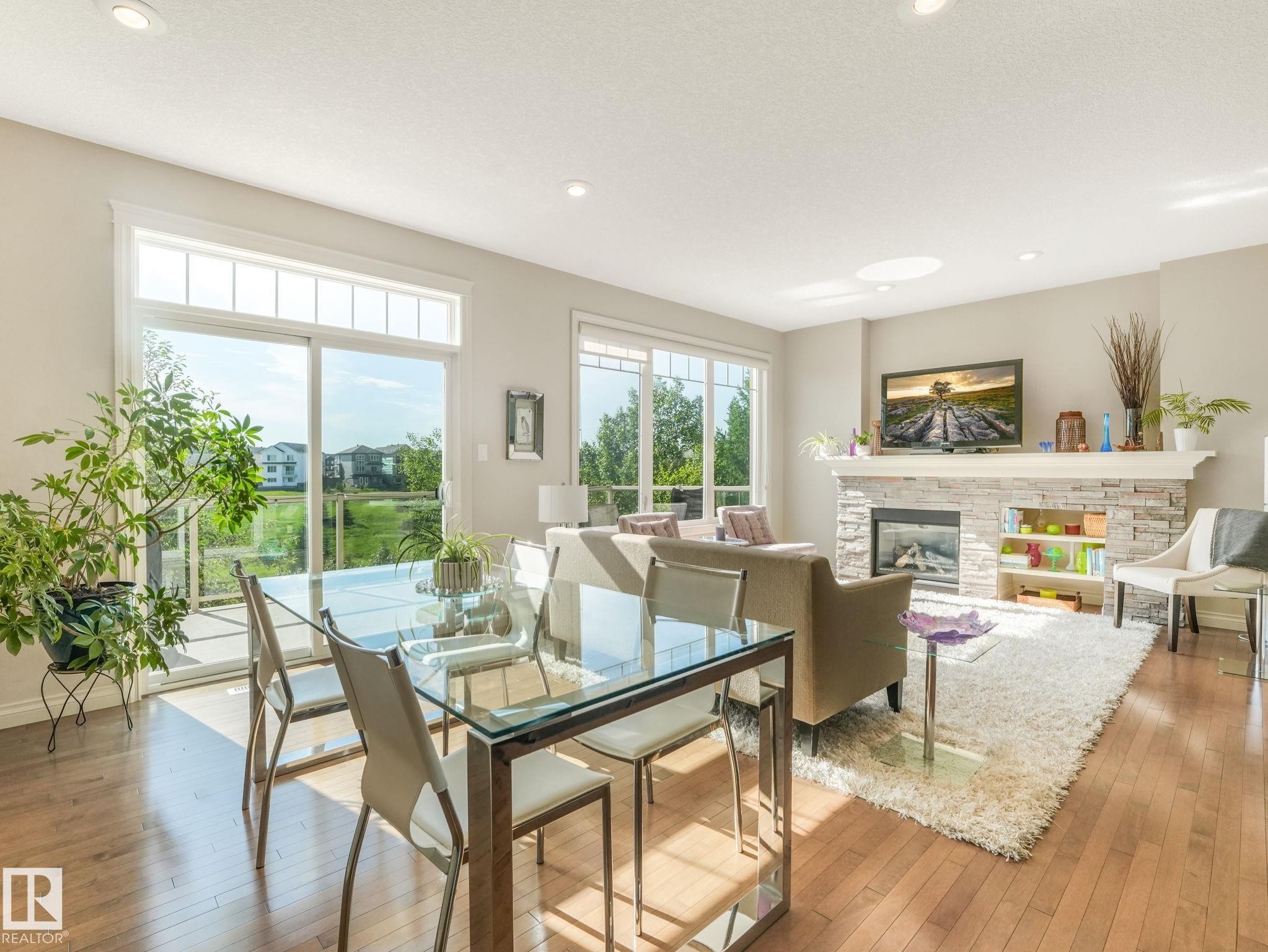 Open-concept living space with wood-finish flooring - 3 1641 James Mowatt Trail, Edmonton, AB