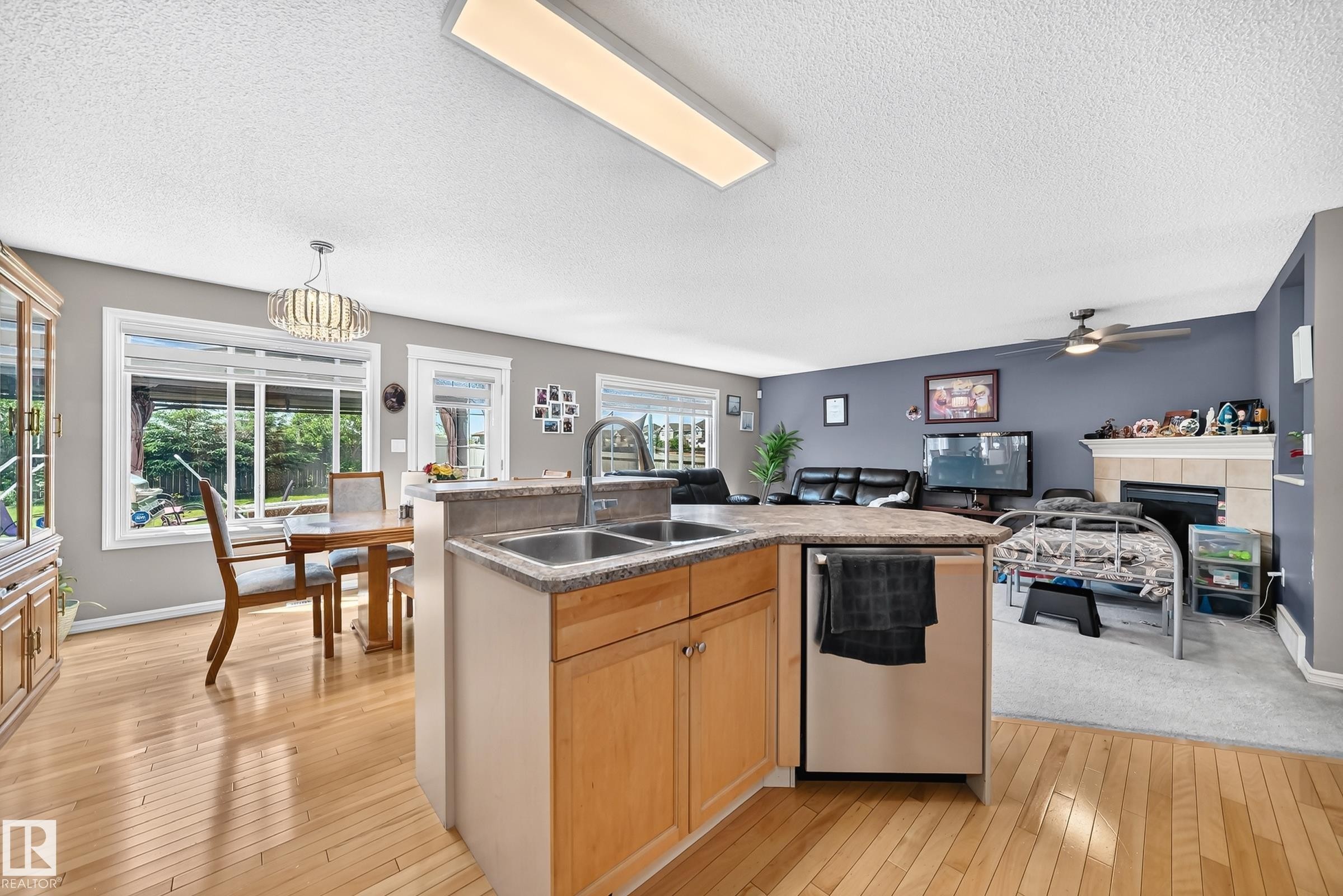 Kitchen island with double basin sink and stainless steel dishwasher - 3224 26 Street, Edmonton, AB