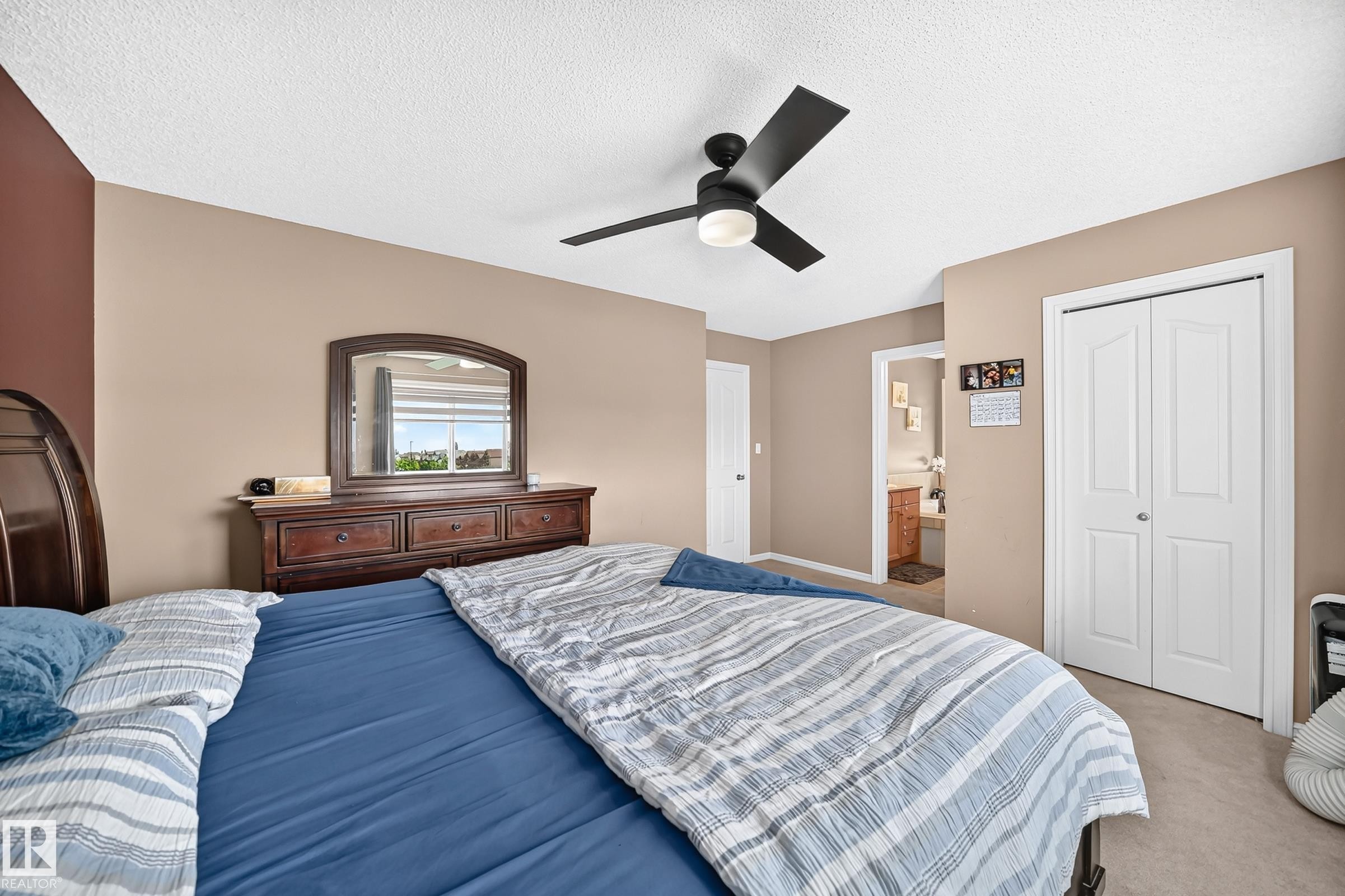 Spacious room featuring neutral tone walls, a ceiling fan with integrated lighting, and carpeted flooring - 3224 26 Street, Edmonton, AB