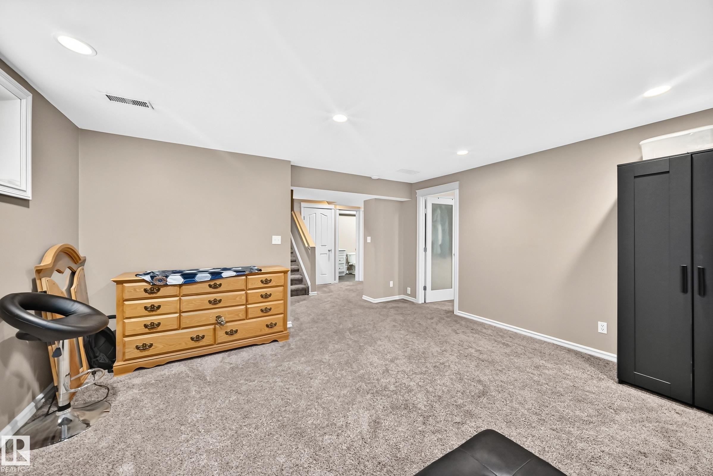 Spacious room featuring neutral wall tones and plush carpeting - 3224 26 Street, Edmonton, AB