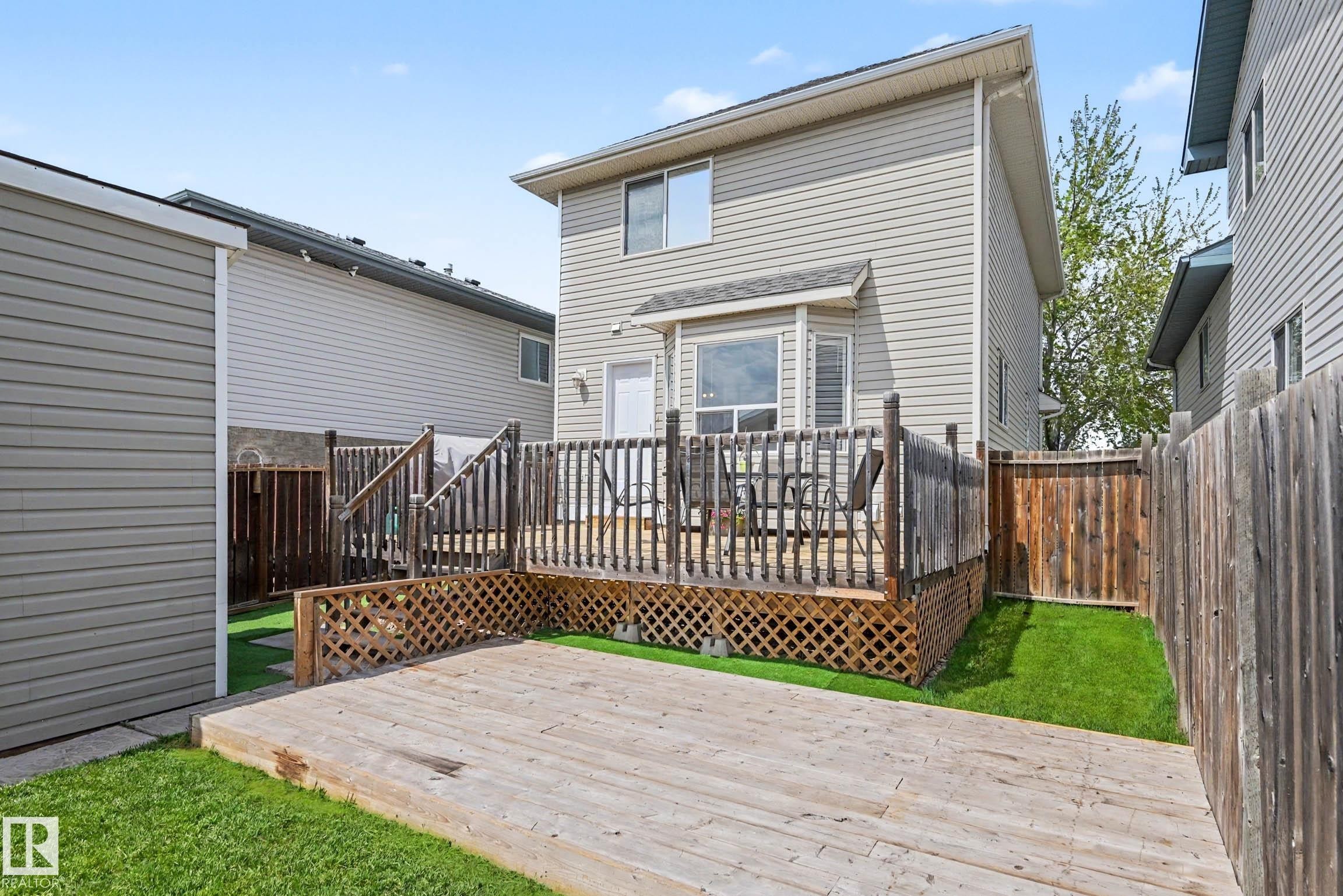 Multi-level outdoor decking with wood lattice accents and a privacy fence - 2123 36 Avenue, Edmonton, AB - Outdoor With Deck Patio Veranda With Exterior
