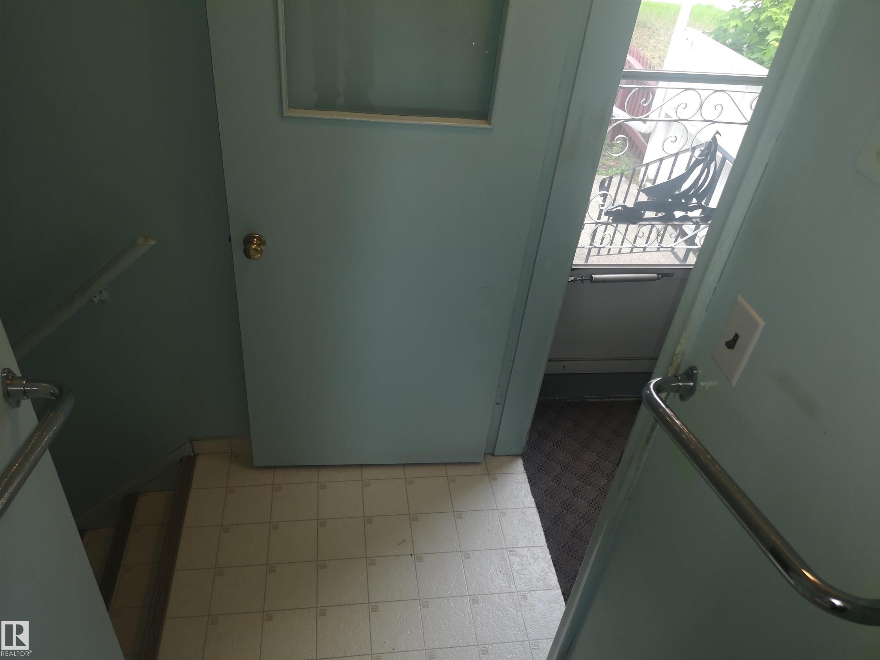 View from kitchen to back door and basement stairs - 8751 76 Avenue Nw, Edmonton, AB