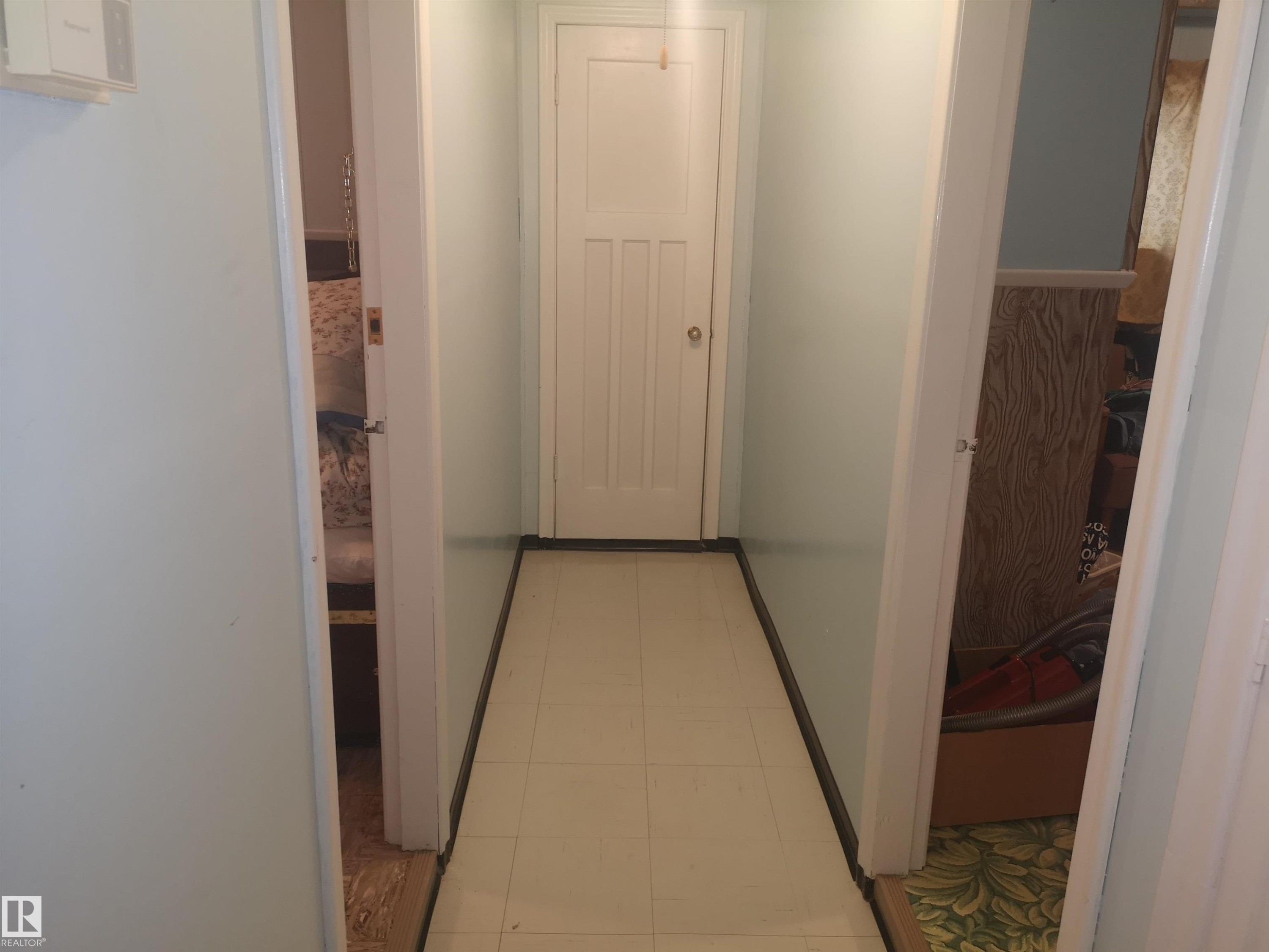 Hallway to front door. Living room on right. - 8751 76 Avenue Nw, Edmonton, AB