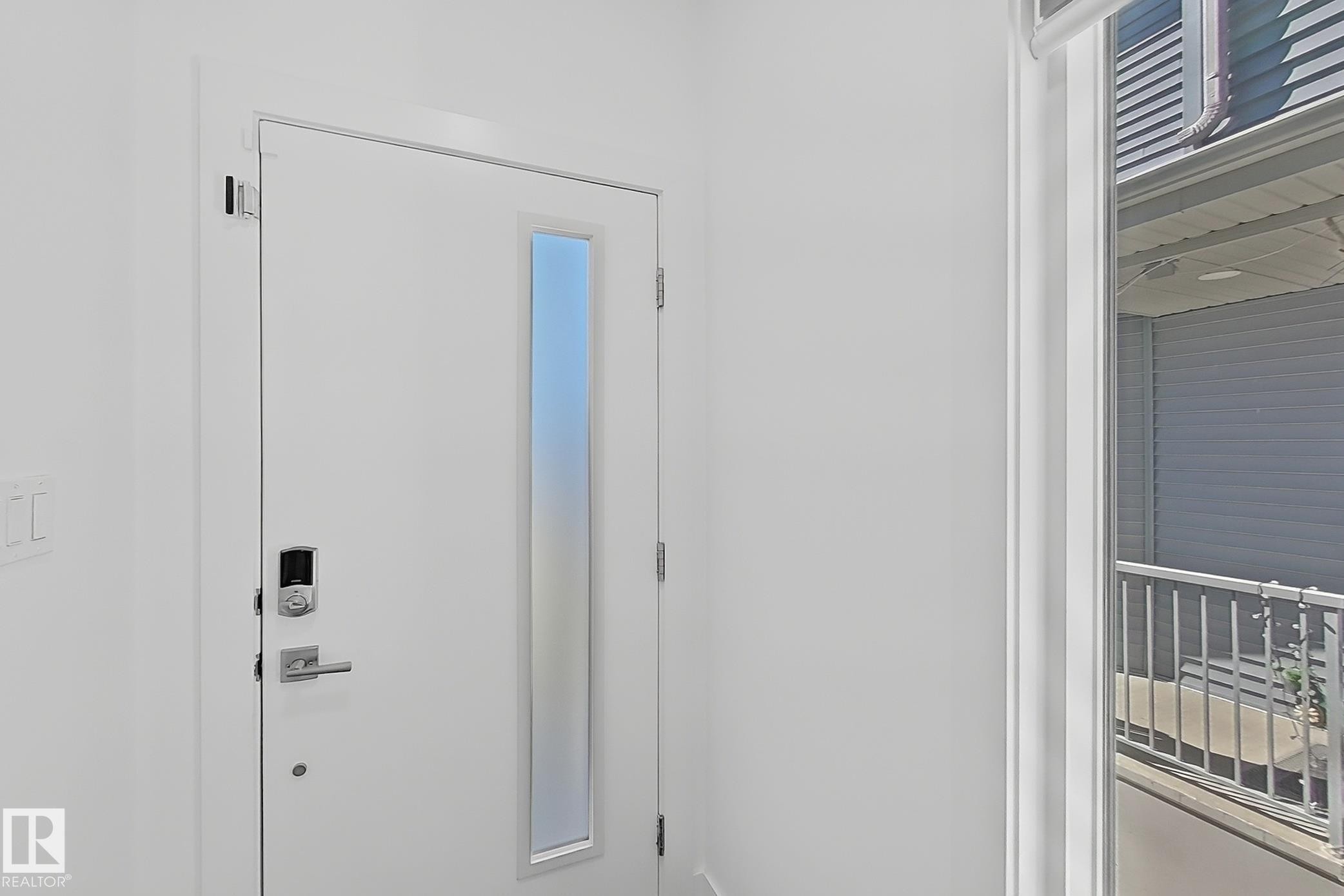 Entry door with frosted vertical lite, smart lock system, and brushed nickel hardware - 415 42 Street, Edmonton, AB