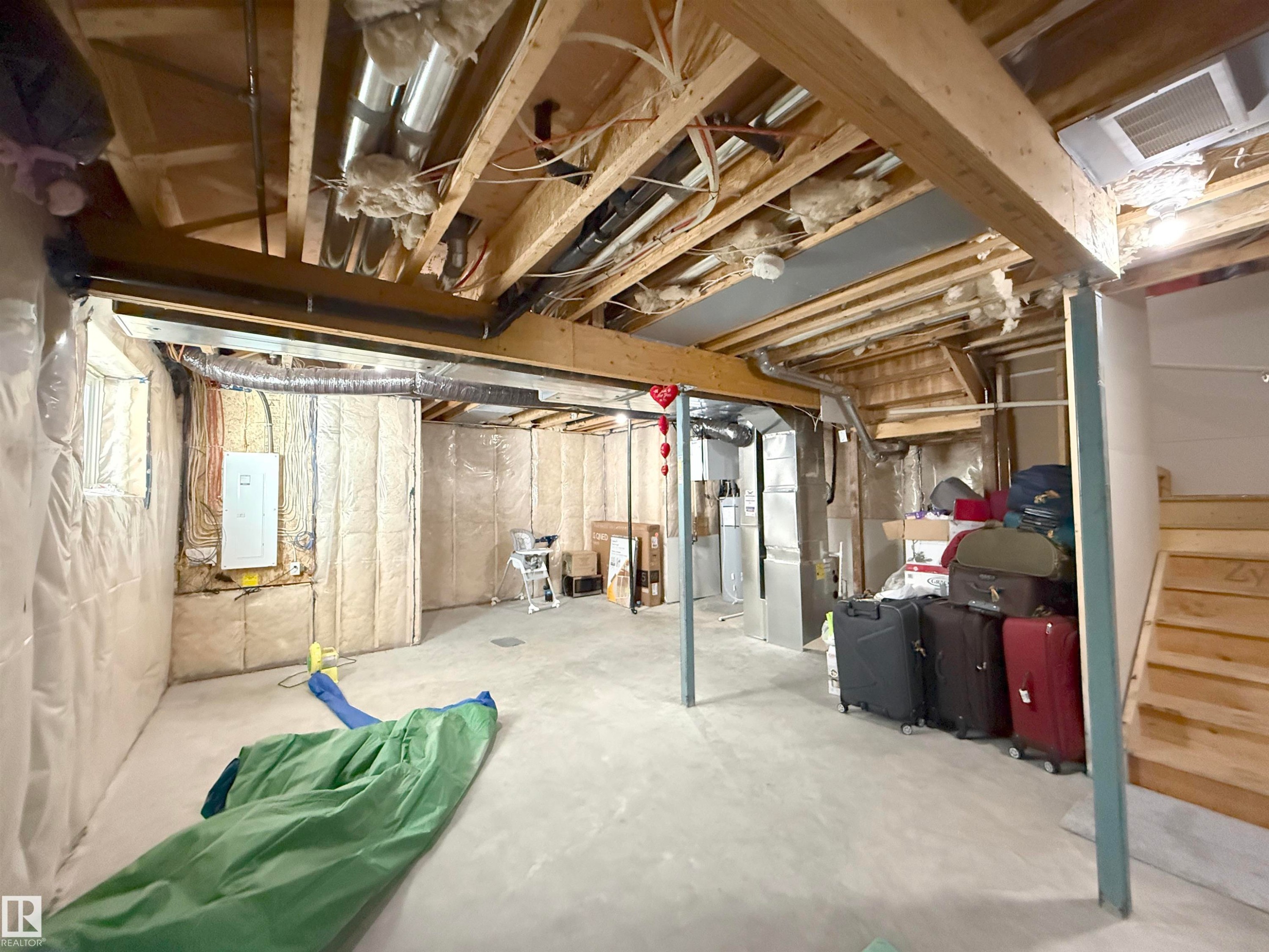 Unfinished basement with concrete flooring and exposed wooden joists - 415 42 Street, Edmonton, AB