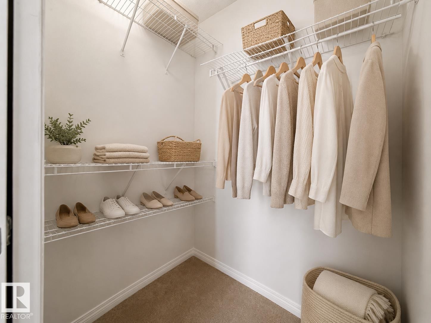 Walk-in closet featuring white wire shelving, hanging rods, and neutral-toned carpeting - 1199 Watt Drive, Edmonton, AB