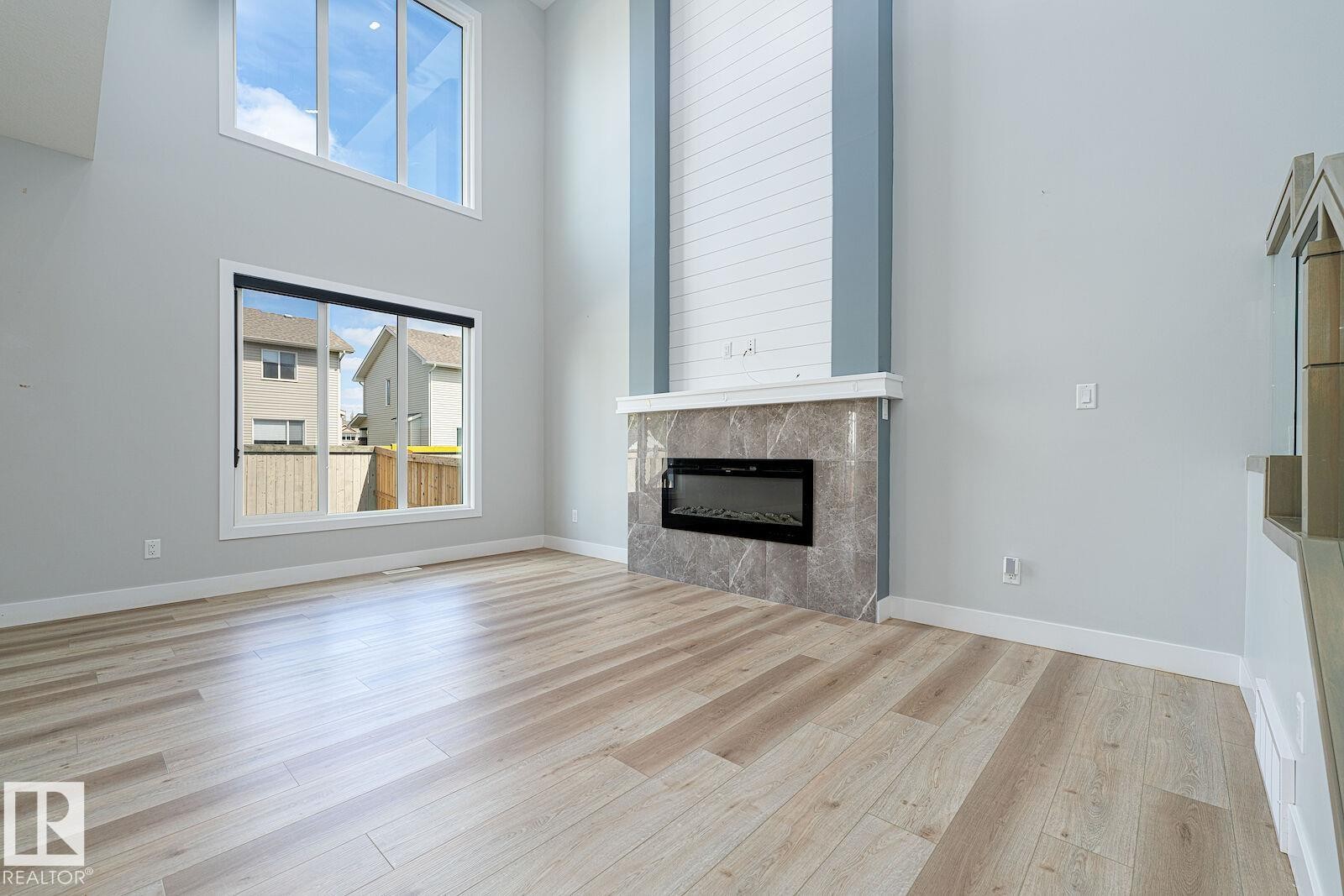 Soaring ceilings and large windows highlight this bright living space - 17320 9 Avenue, Edmonton, AB