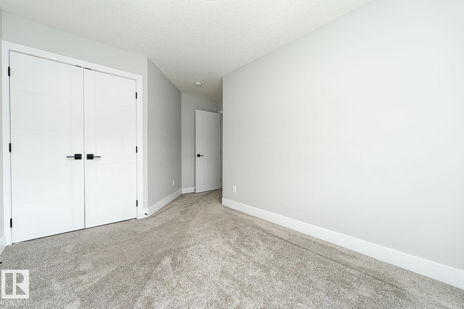Wall-to-wall carpeting with a light gray hue - 17320 9 Avenue, Edmonton, AB