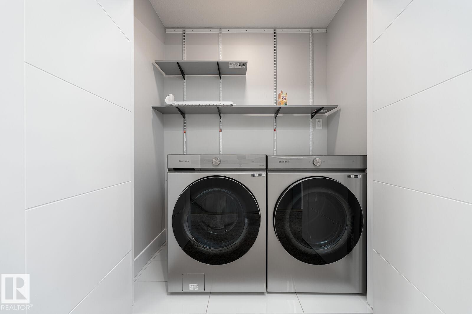 Dedicated laundry area featuring modern front-loading washer and dryer units - 17320 9 Avenue, Edmonton, AB