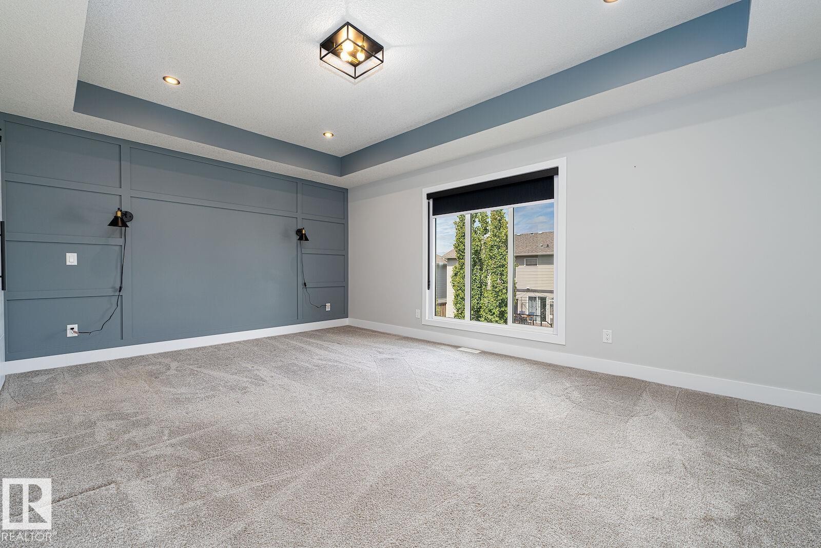 Recessed ceiling with a contrasting painted accent panel and flush mount lighting - 17320 9 Avenue, Edmonton, AB