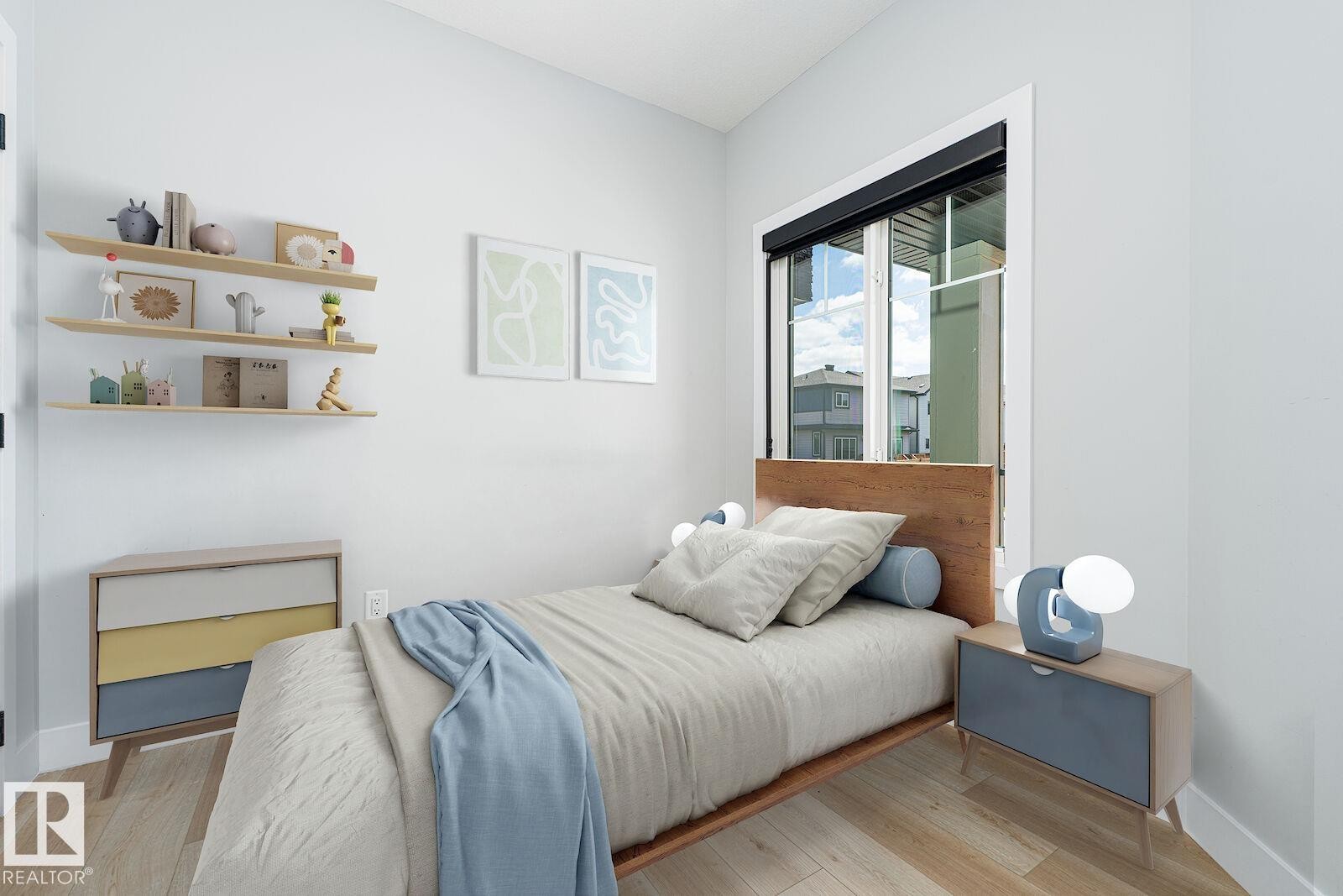 Bedroom featuring light wood-finish flooring, a window with a black roller shade, and white baseboards - 17320 9 Avenue, Edmonton, AB
