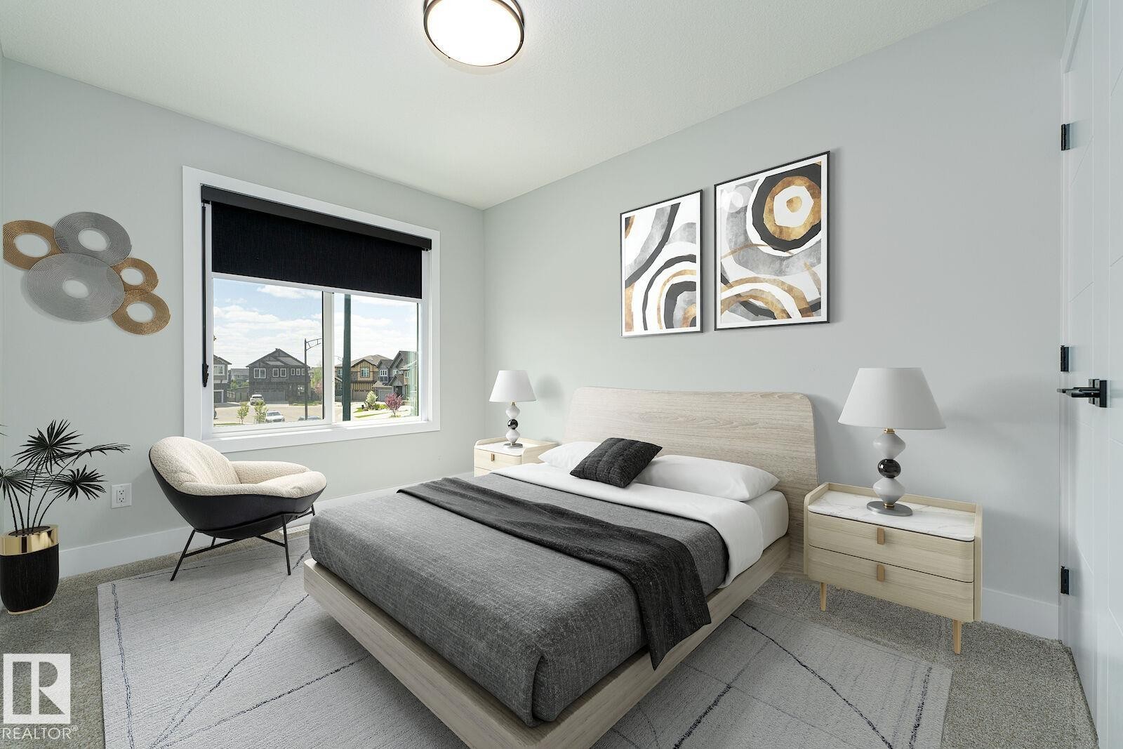 Light-filled bedroom featuring a large window with a black roller shade, light-toned walls, and plush carpet flooring - 17320 9 Avenue, Edmonton, AB
