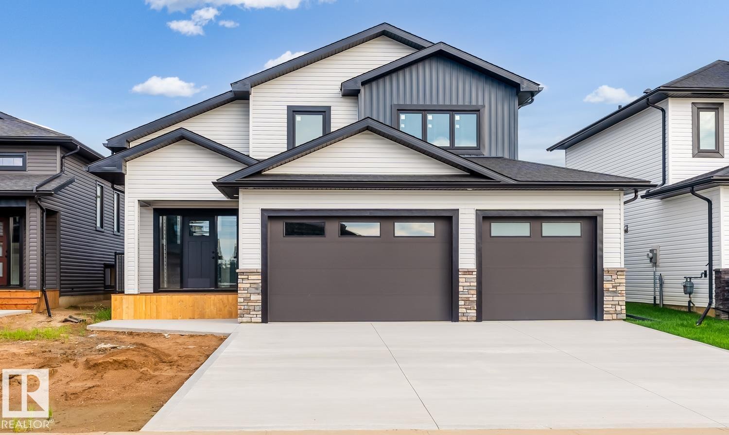 Modern two-story residence featuring a dual-tone exterior with light siding and dark vertical accents - 301 Fundy Way, Cold Lake, AB - Outdoor With Facade