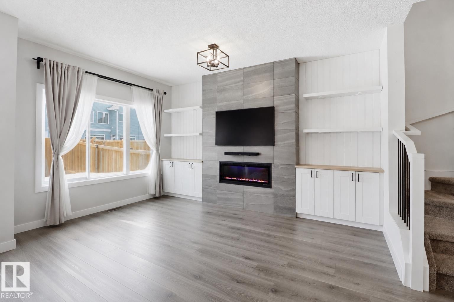 Open living area featuring light wood-finish flooring - 3234 Chernowski Way, Edmonton, AB
