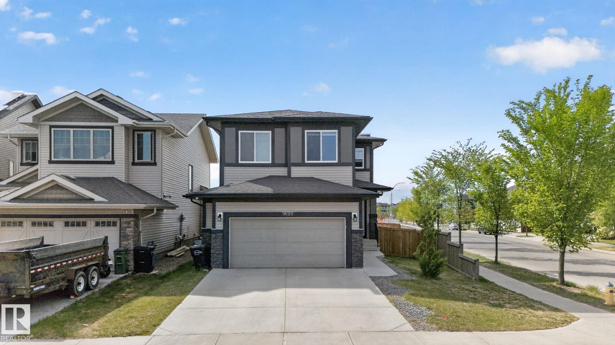 Two-story residence featuring a two-car garage with a concrete driveway - 9628 221 Street, Edmonton, AB