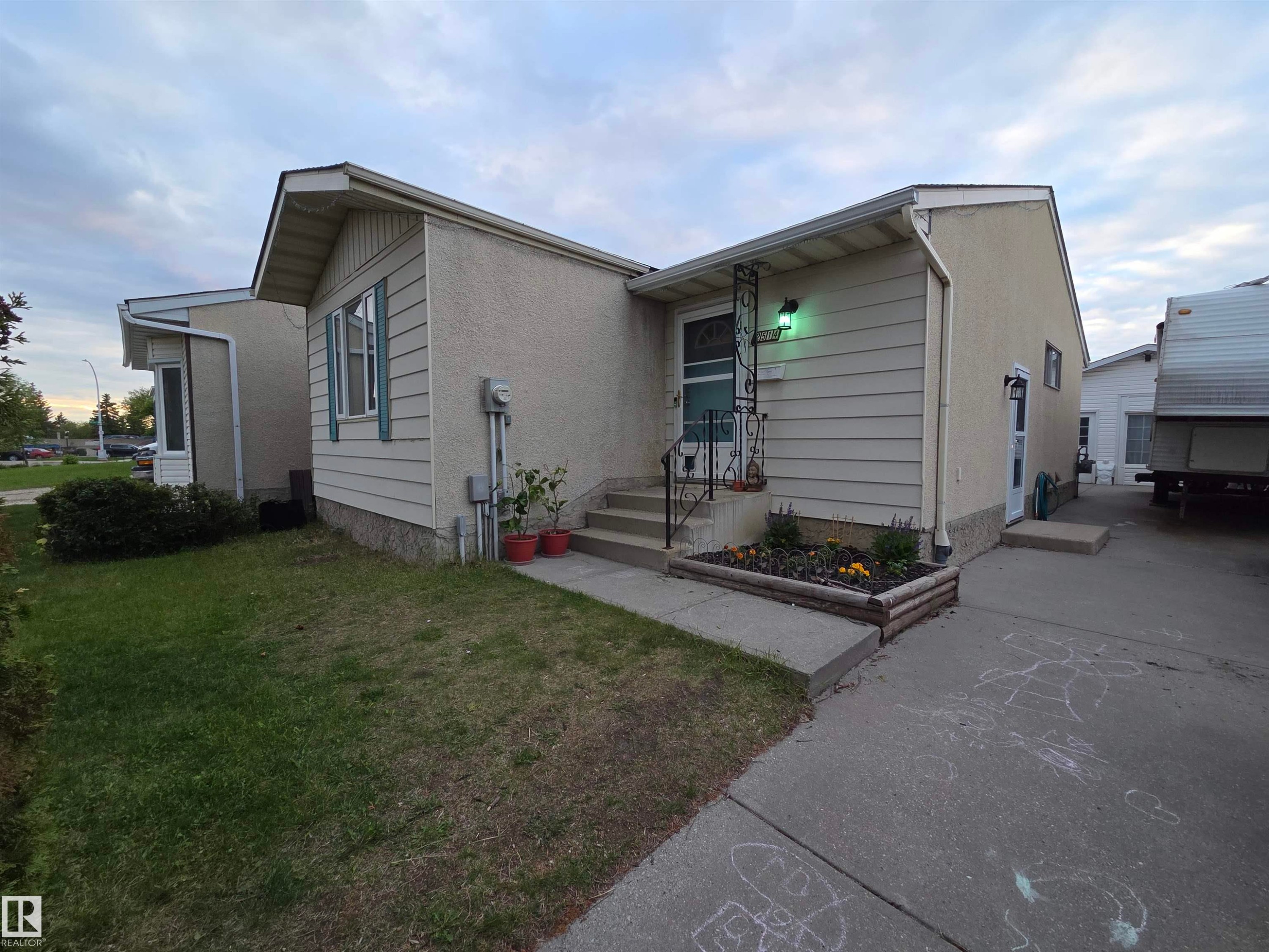 Stucco and siding exterior with a concrete driveway and walkway - 2514 149 Avenue, Edmonton, AB