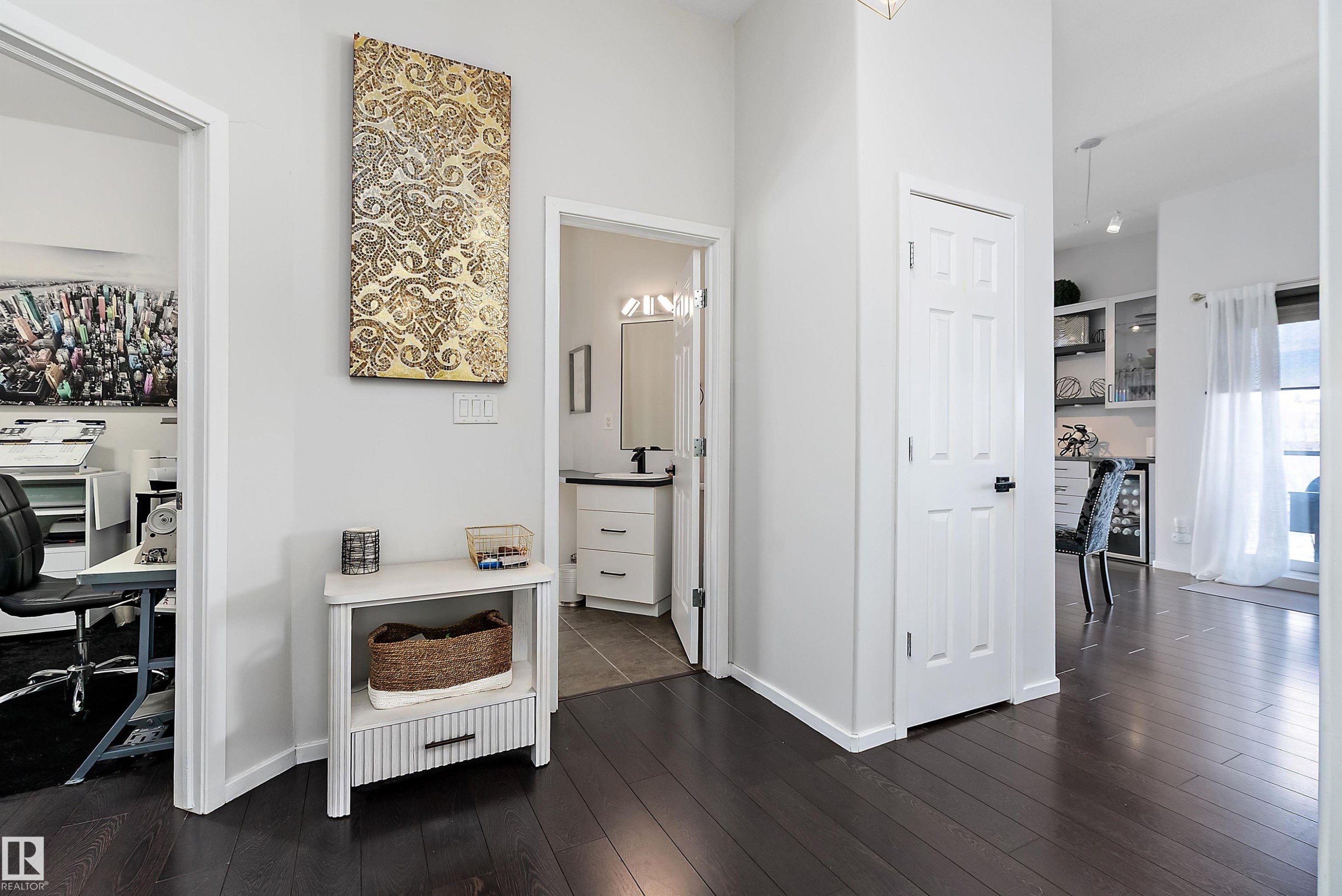 Hall featuring a desk, dark wood-style flooring, and beverage cooler - 302 10905 109 Street, Edmonton, AB