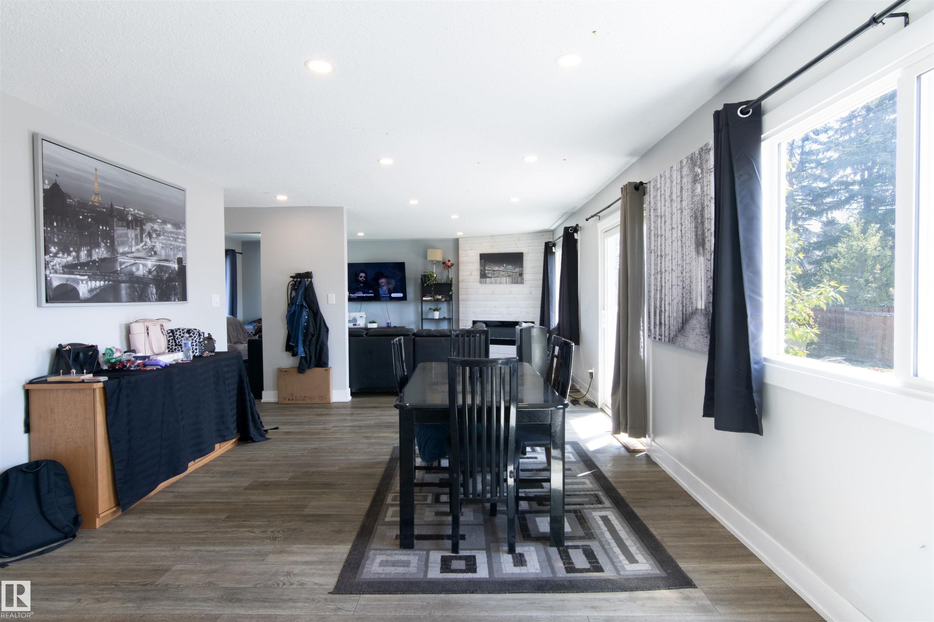 Open-concept living space featuring wood-finish flooring, recessed lighting, and ample natural light from multiple windows - 7115 39A Avenue, Edmonton, AB - Indoor Photo Showing Other Room