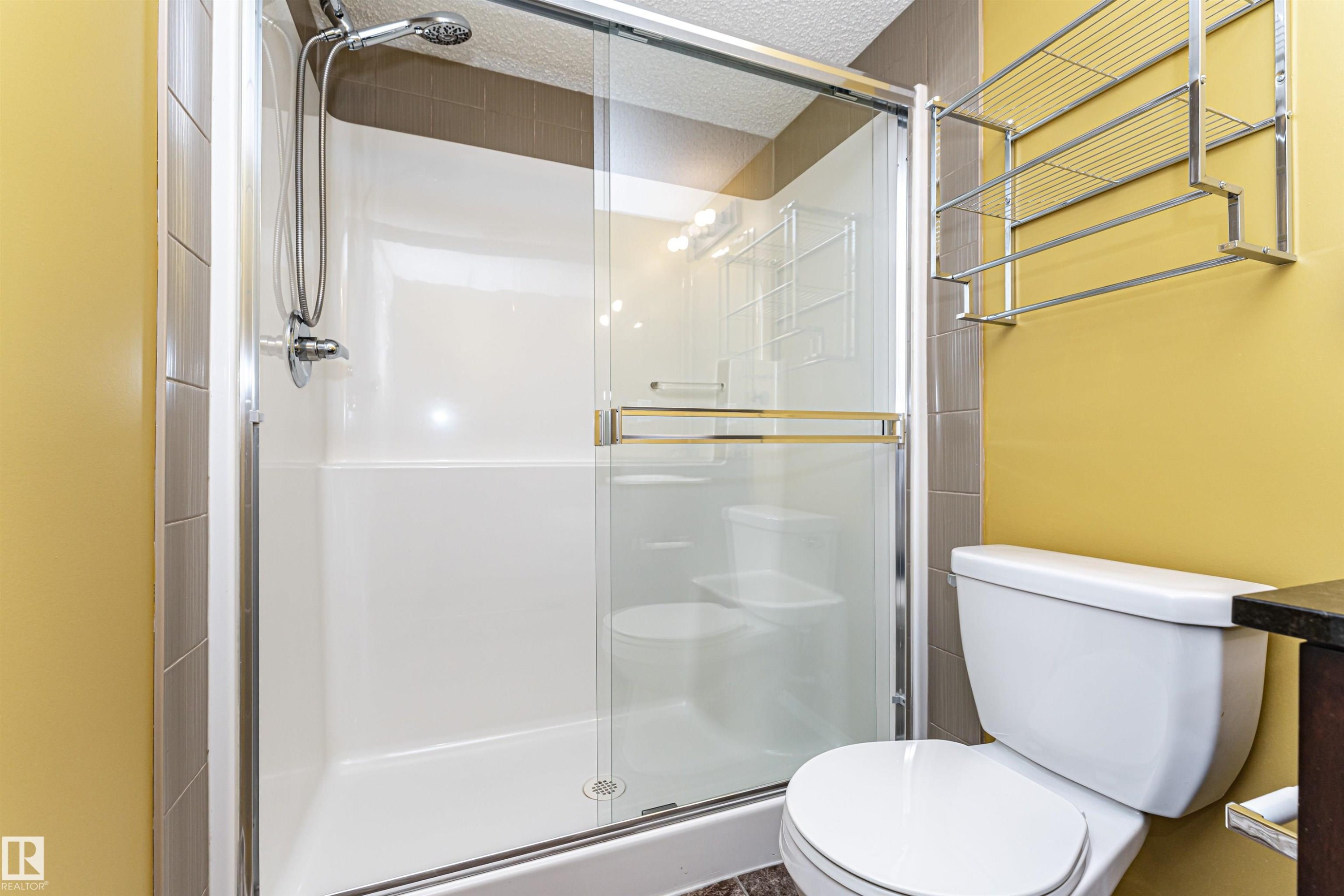 Walk-in shower with a glass enclosure and chrome fixtures - 404 12045 22 Avenue, Edmonton, AB