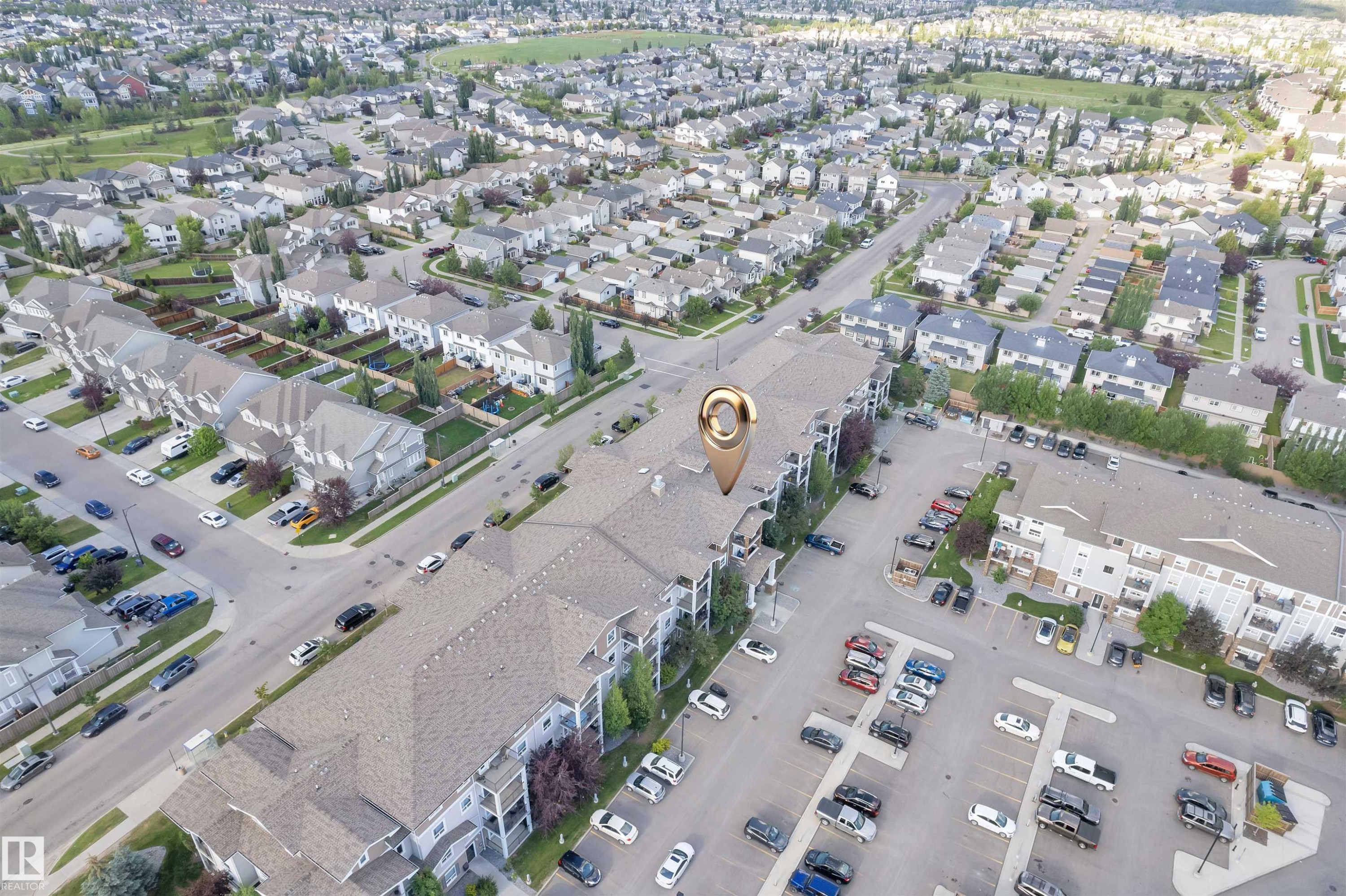 Multi-story residential building with private balconies and surface parking - #3302 9351 Simpson Dr Nw, Edmonton, AB