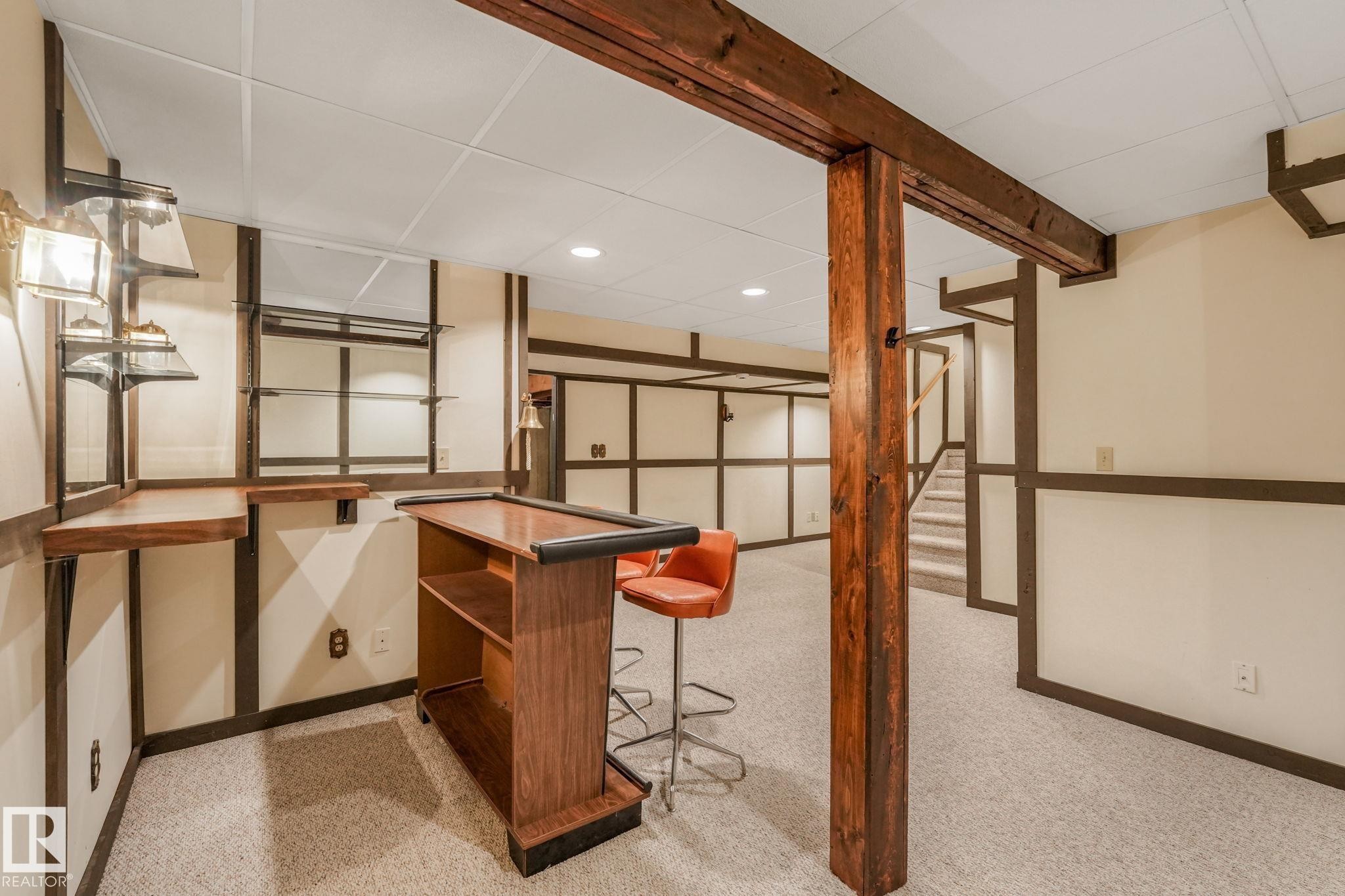 Bar with built-in shelving and sconce lighting. - 2921 130 Avenue, Edmonton, AB