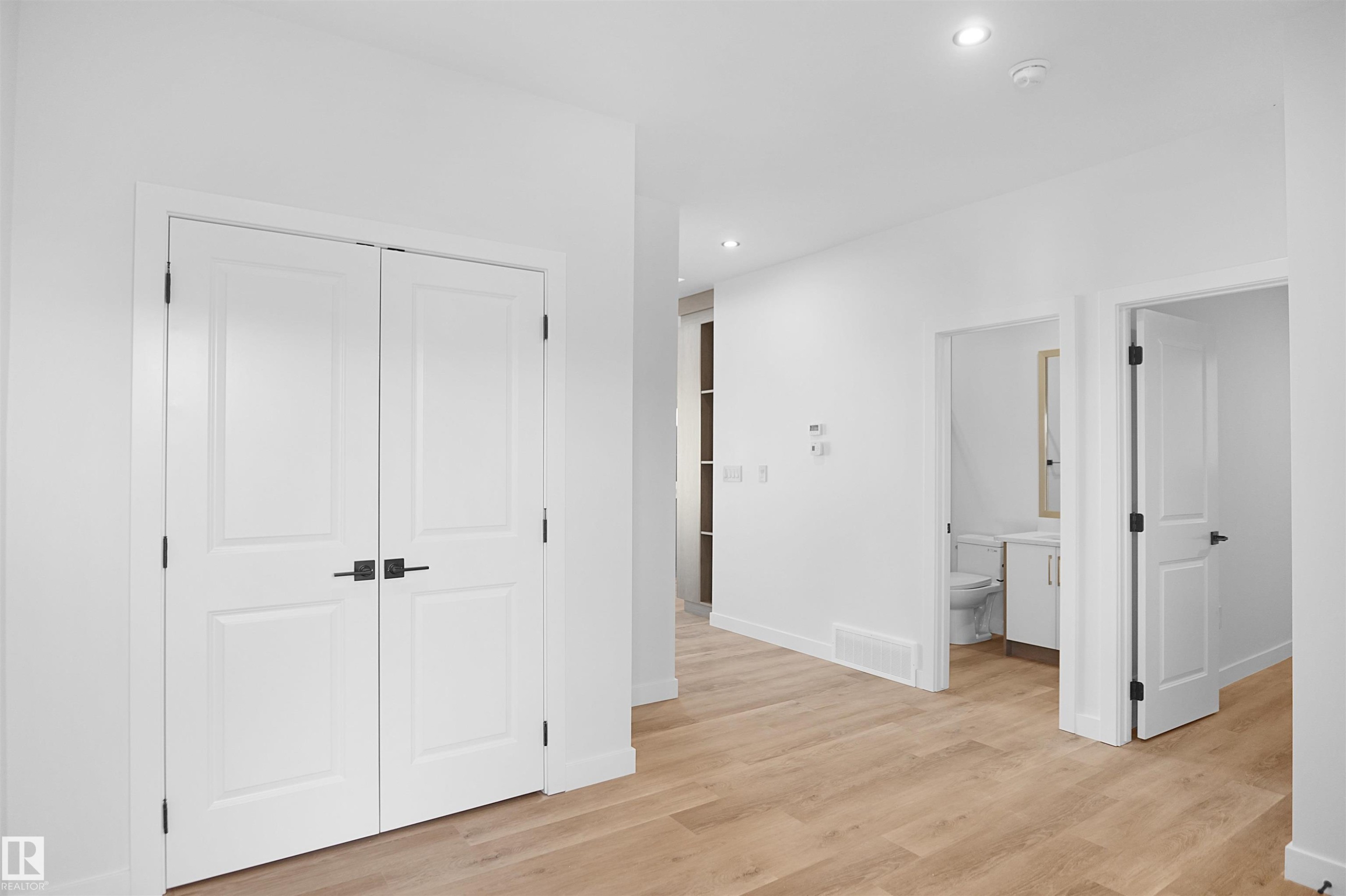 Hallway with wood-finish flooring and recessed lighting - 6403 29 Ave, Edmonton, AB - Indoor Photo Showing Other Room