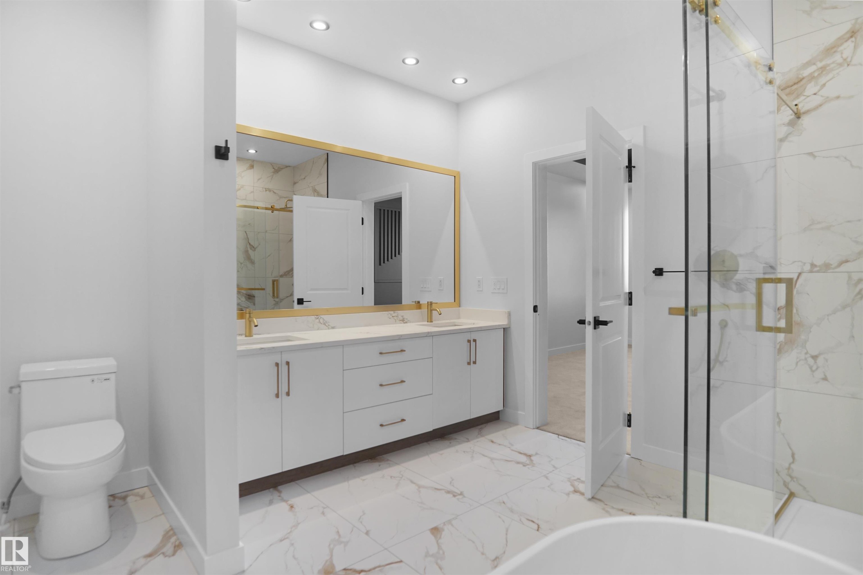 Contemporary bathroom featuring a double vanity with white cabinetry, gold hardware, and a quartz countertop - 6403 29 Ave, Edmonton, AB - Indoor Photo Showing Bathroom