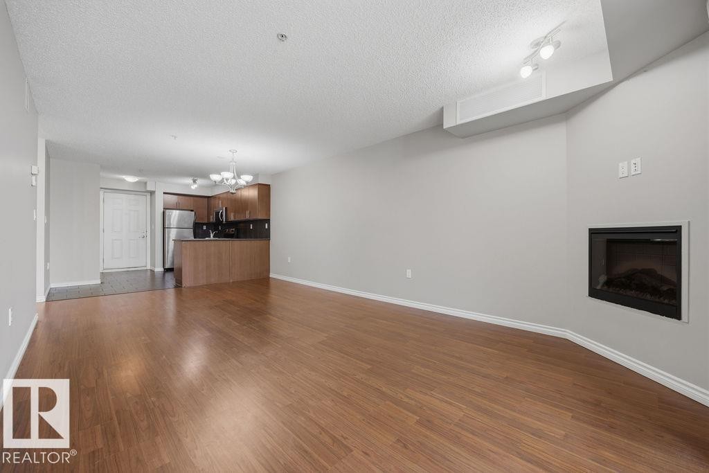 204 10118 106 Avenue, Edmonton, AB - Indoor Photo Showing Other Room With Fireplace