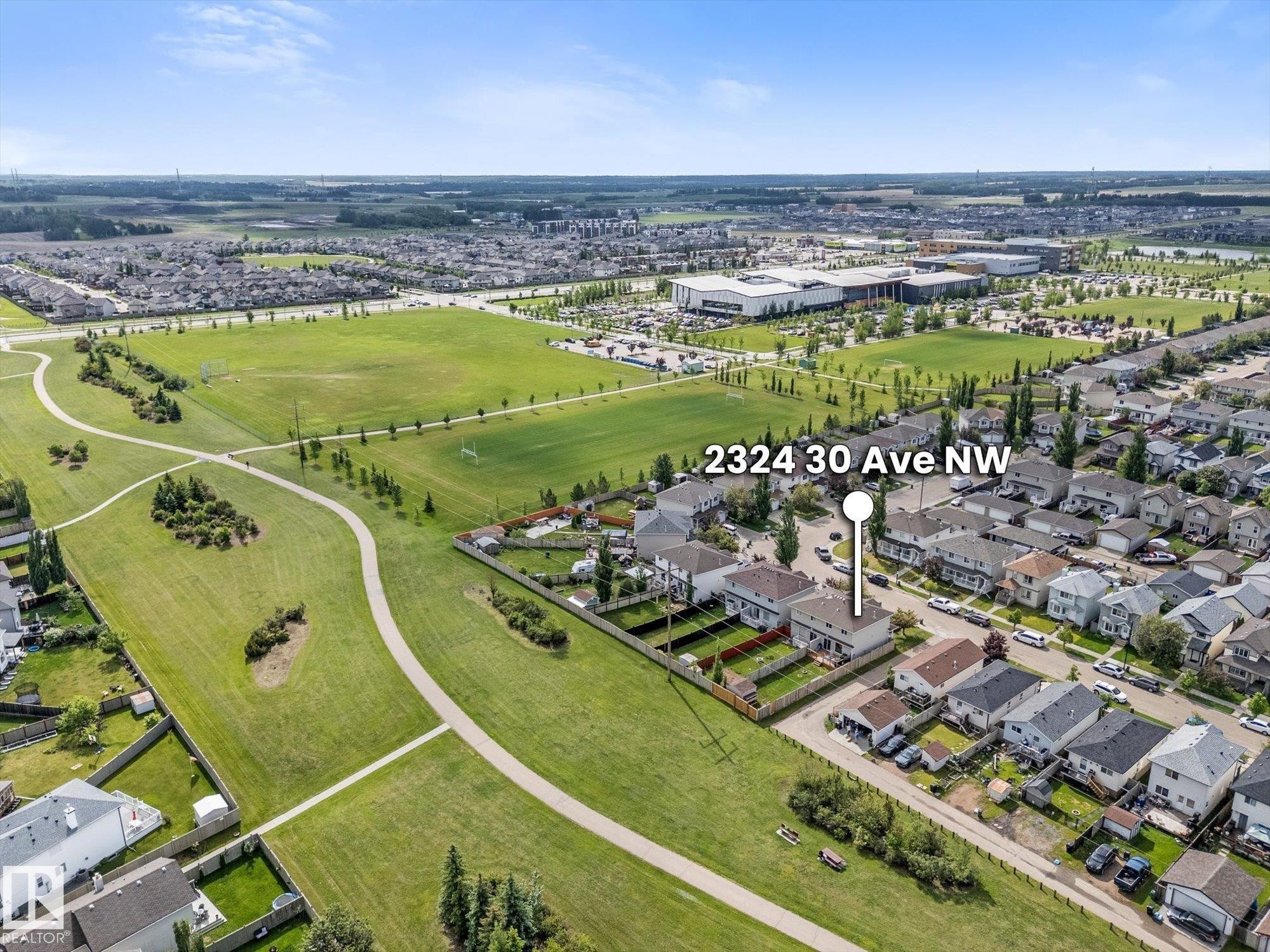 Aerial perspective showcasing a residential street with homes featuring fenced backyards - 2324 30 Avenue, Edmonton, AB
