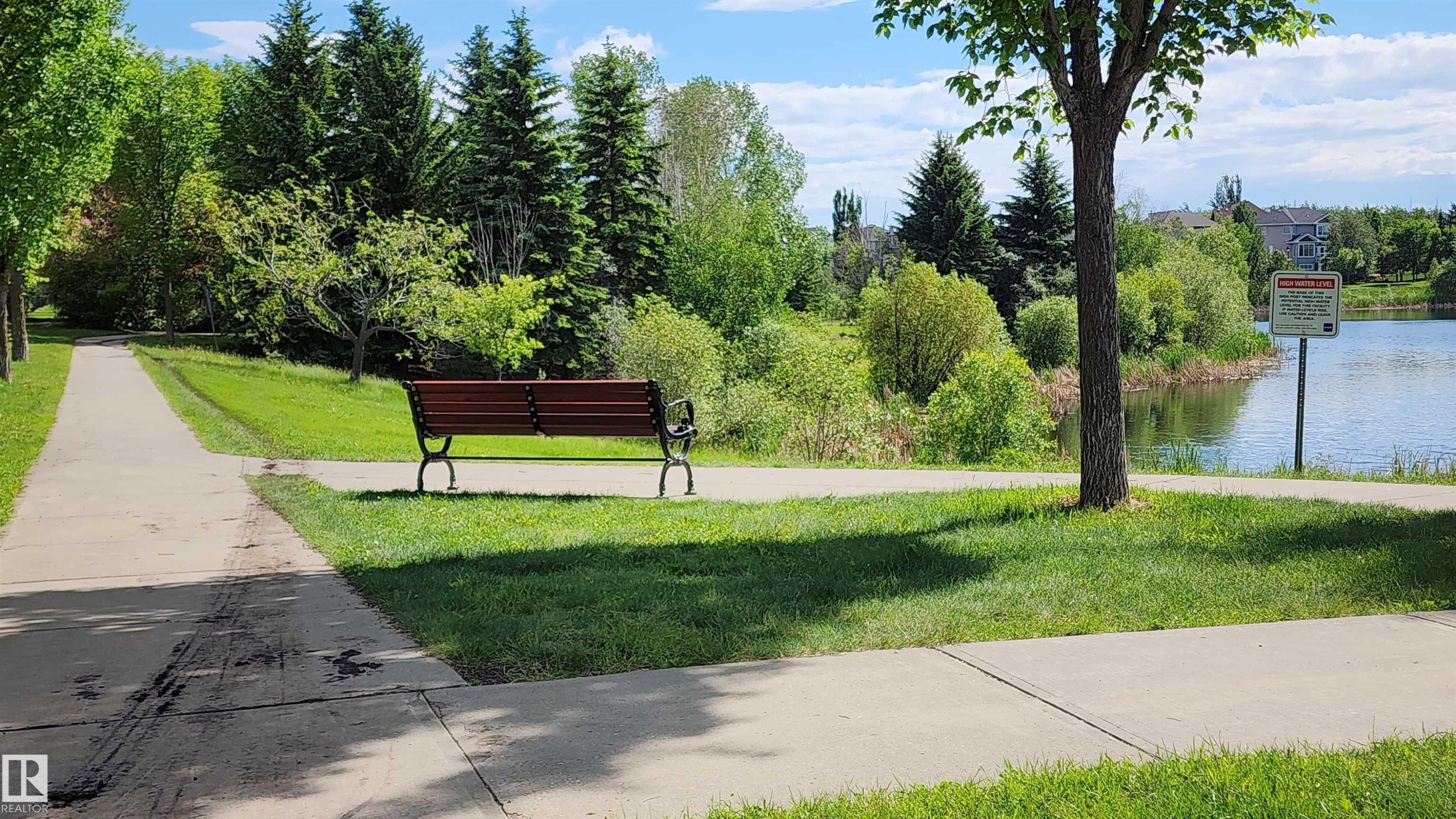 Nearby pond with parkbench for nature watching - 1712 Tomlinson Common, Edmonton, AB