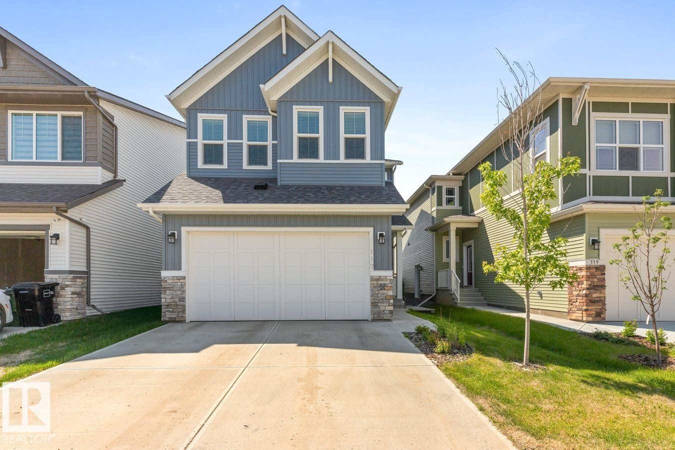 Contemporary two-story residence with blue vertical siding and white trim accents - 117 Paisley Gate Gate, Edmonton, AB
