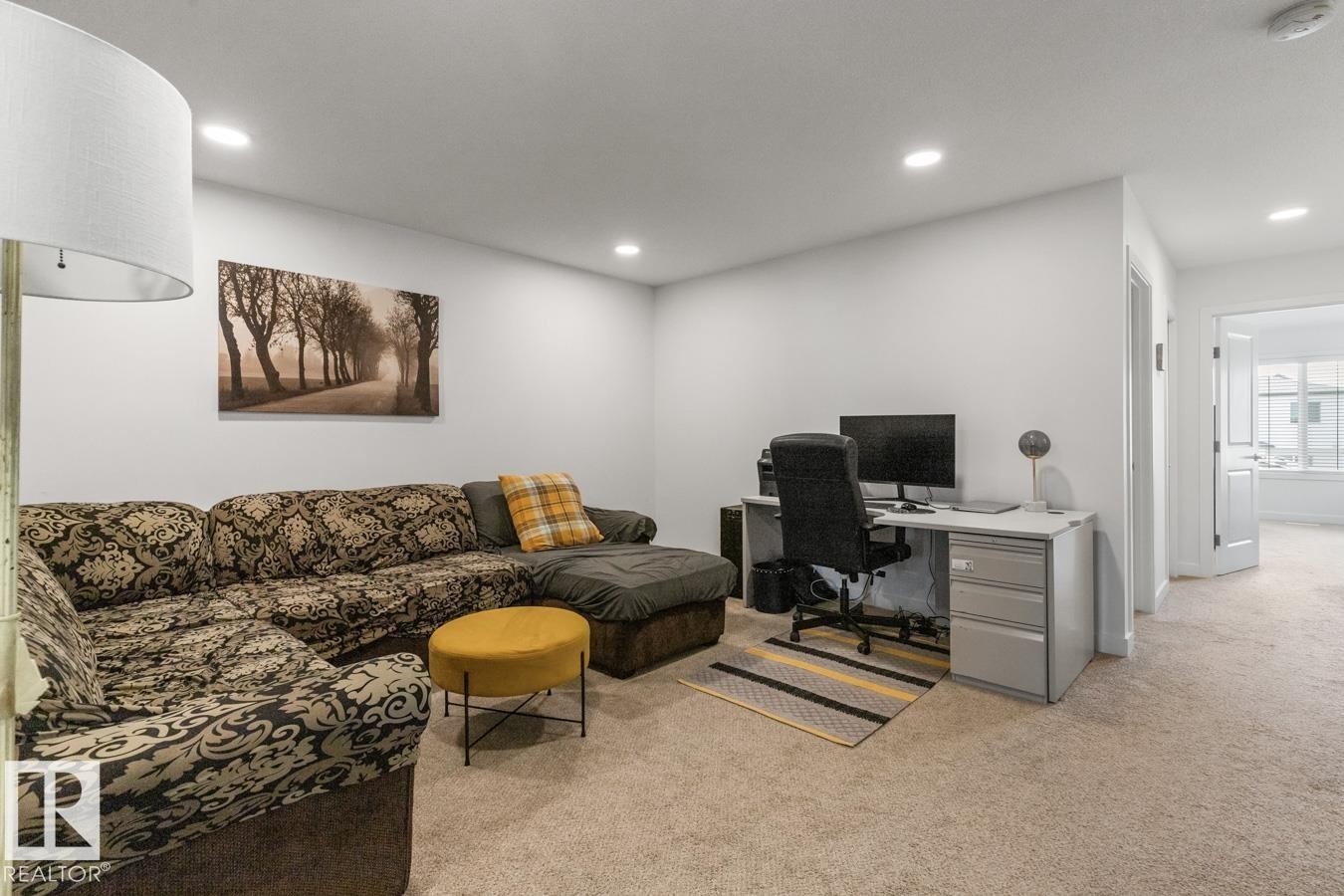 Carpeted interior space featuring recessed lighting, white walls, and a white six-panel interior door - 117 Paisley Gate Gate, Edmonton, AB