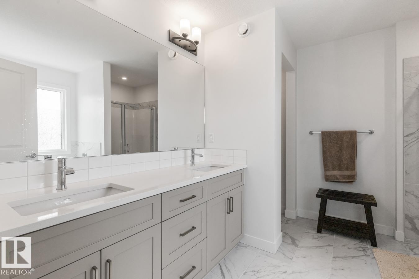 Double vanity with light gray cabinetry, white countertops, and undermount sinks - 117 Paisley Gate Gate, Edmonton, AB