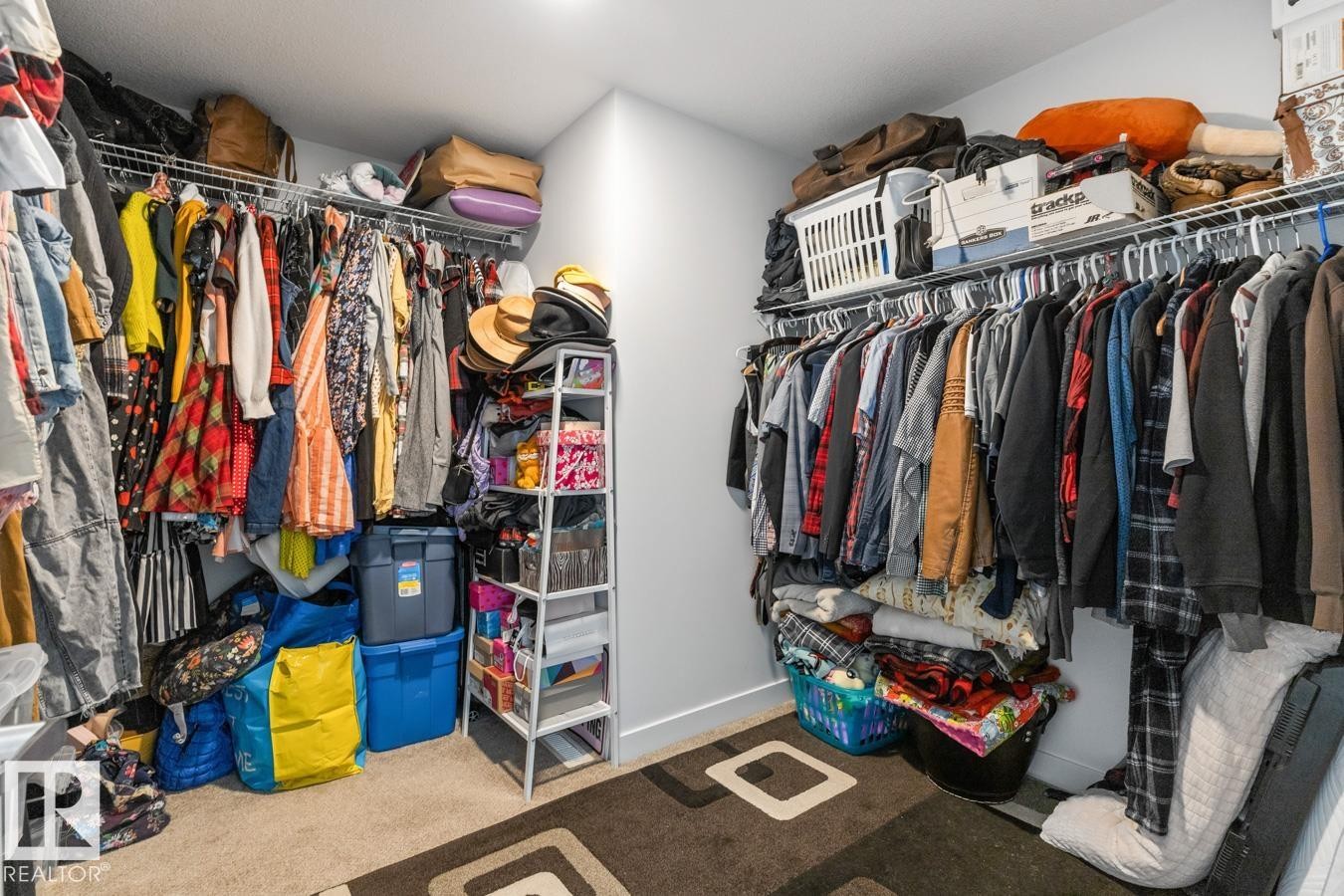 Walk-in closet featuring built-in wire shelving and hanging rods - 117 Paisley Gate Gate, Edmonton, AB