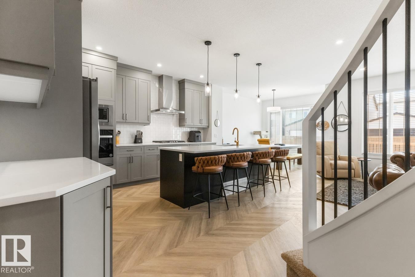 Modern kitchen featuring light gray cabinetry, stainless steel appliances, and a white subway tile backsplash - 117 Paisley Gate Gate, Edmonton, AB