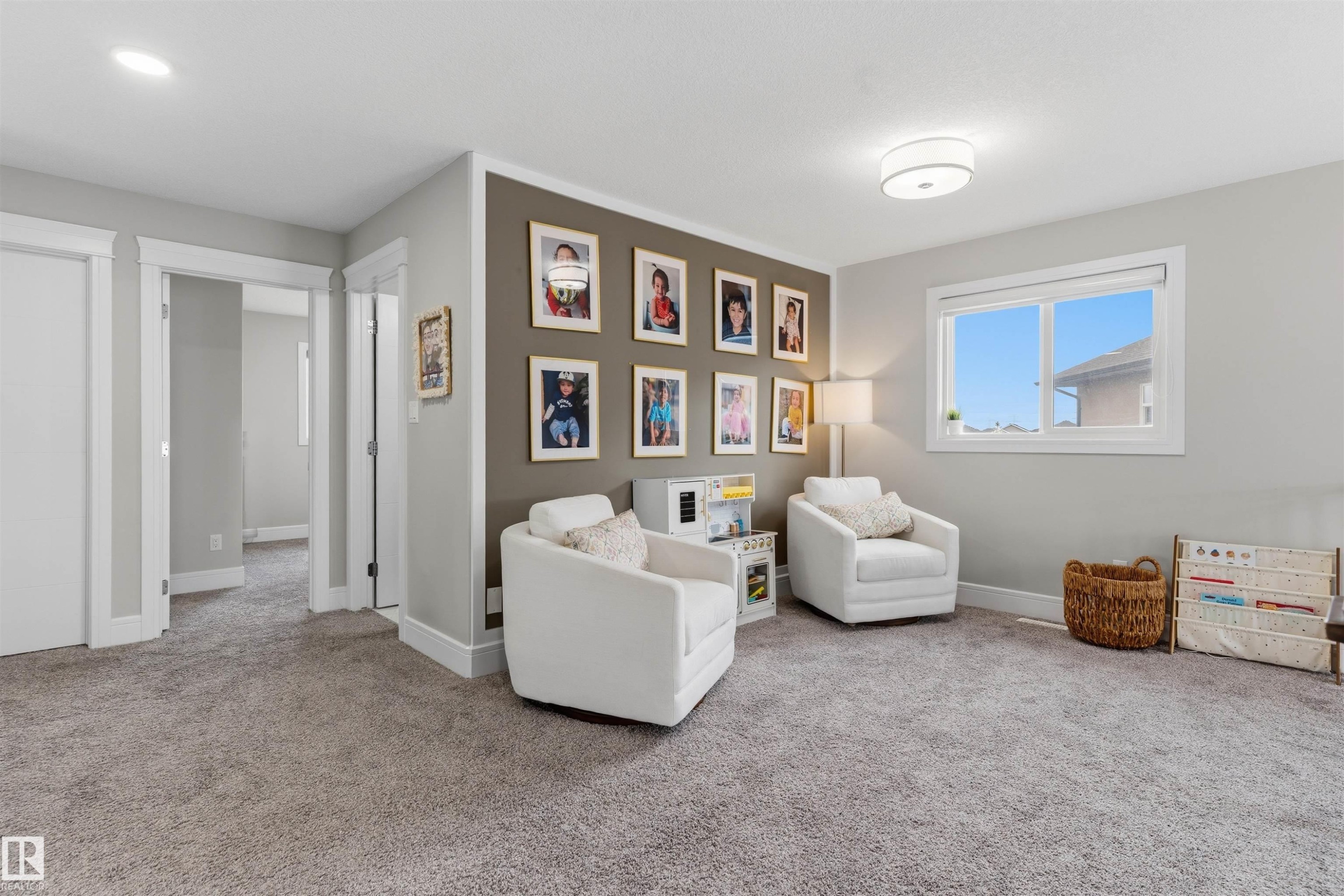 Carpeted room featuring a window, recessed lighting, and a prominent accent wall - 3312 11 Avenue, Edmonton, AB