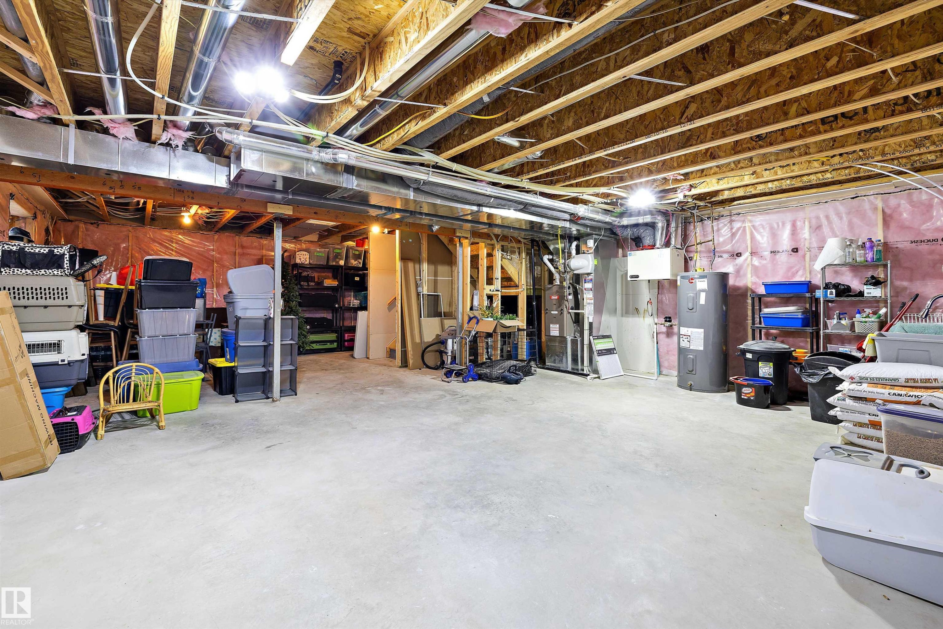 Unfinished basement with concrete flooring and exposed ceiling joists - 363 Cy Becker Boulevard, Edmonton, AB - Indoor Photo Showing Basement